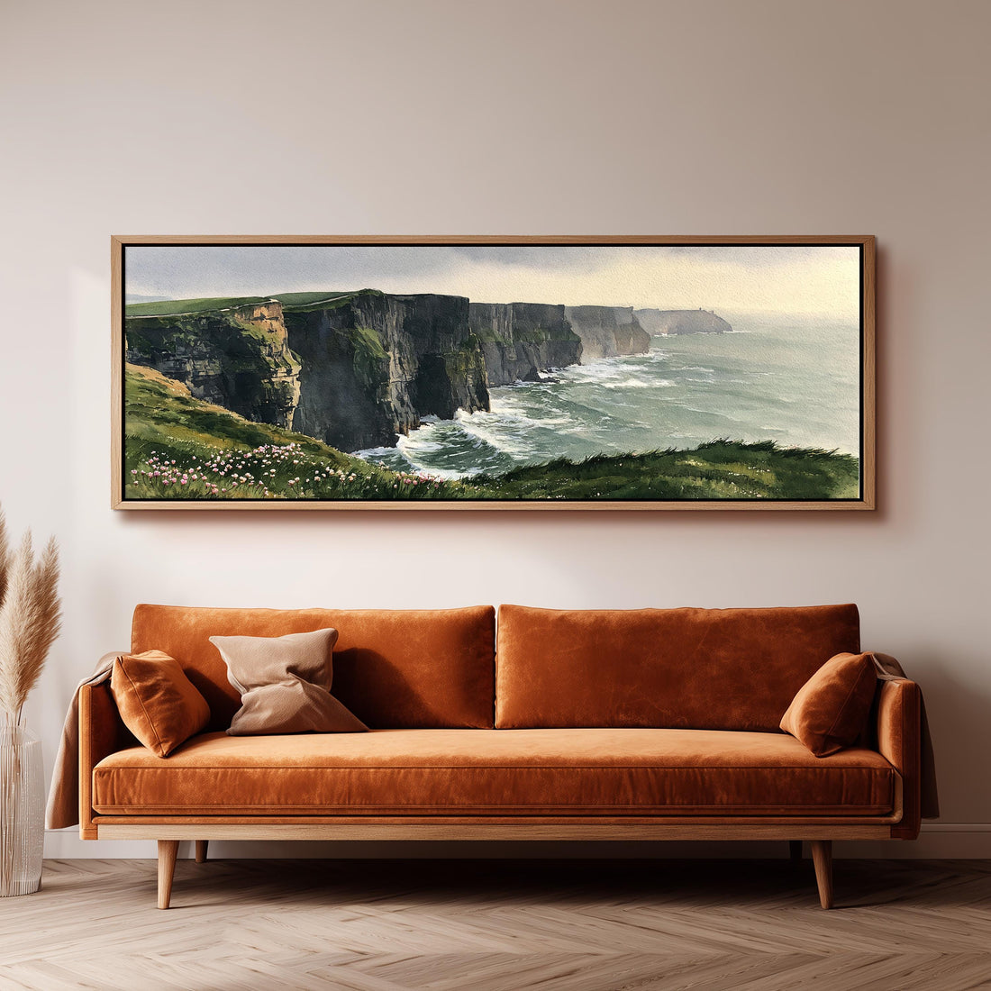 Green sea cliffs with wildflowers long horizontal canvas print above a sofa in a living room