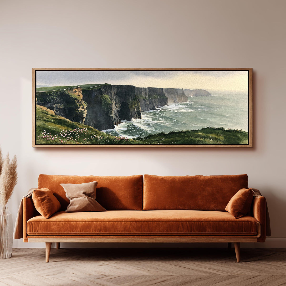Green sea cliffs with wildflowers long horizontal canvas print above a sofa in a living room