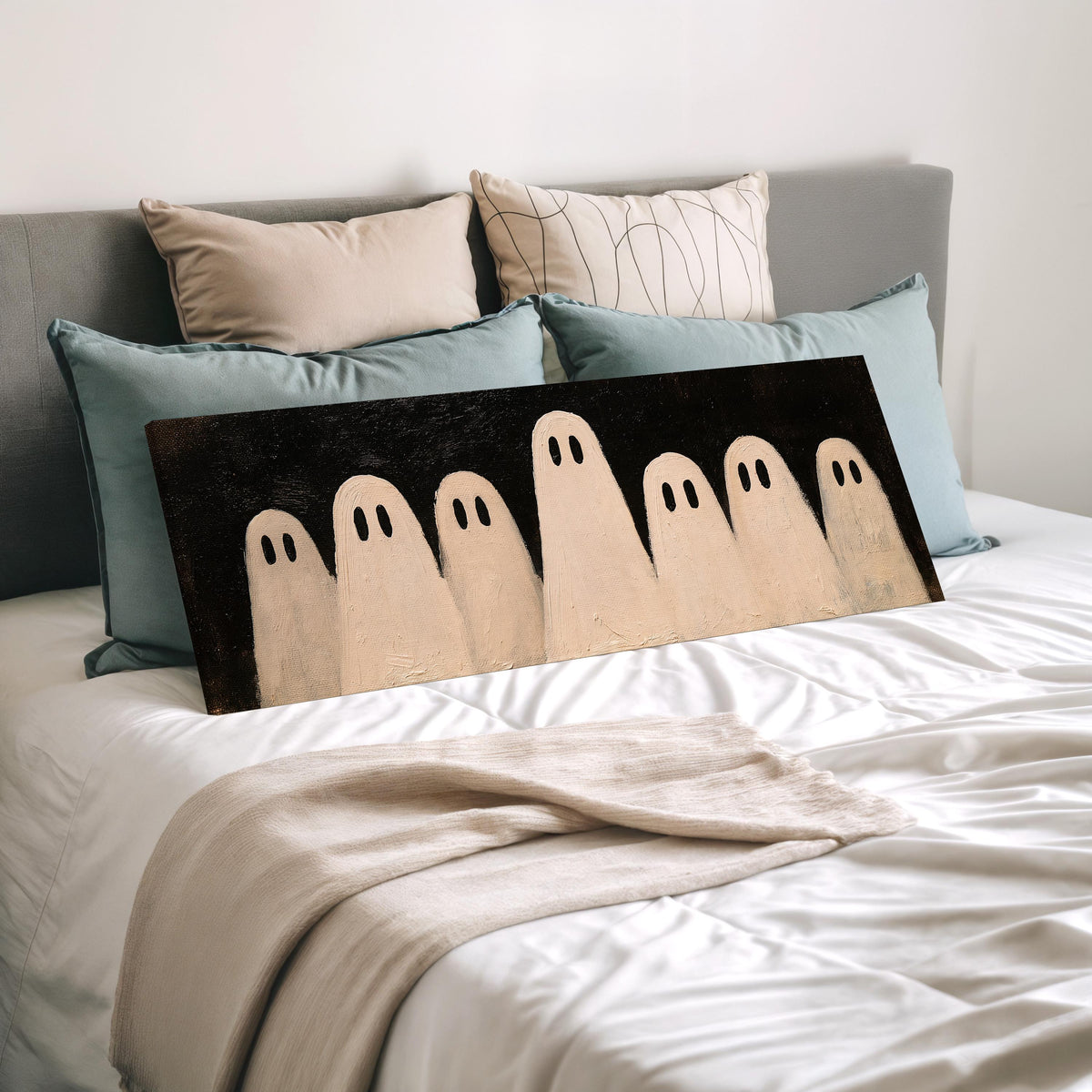 Friendly ghost gang wide panoramic canvas print laid on a bed to show its size