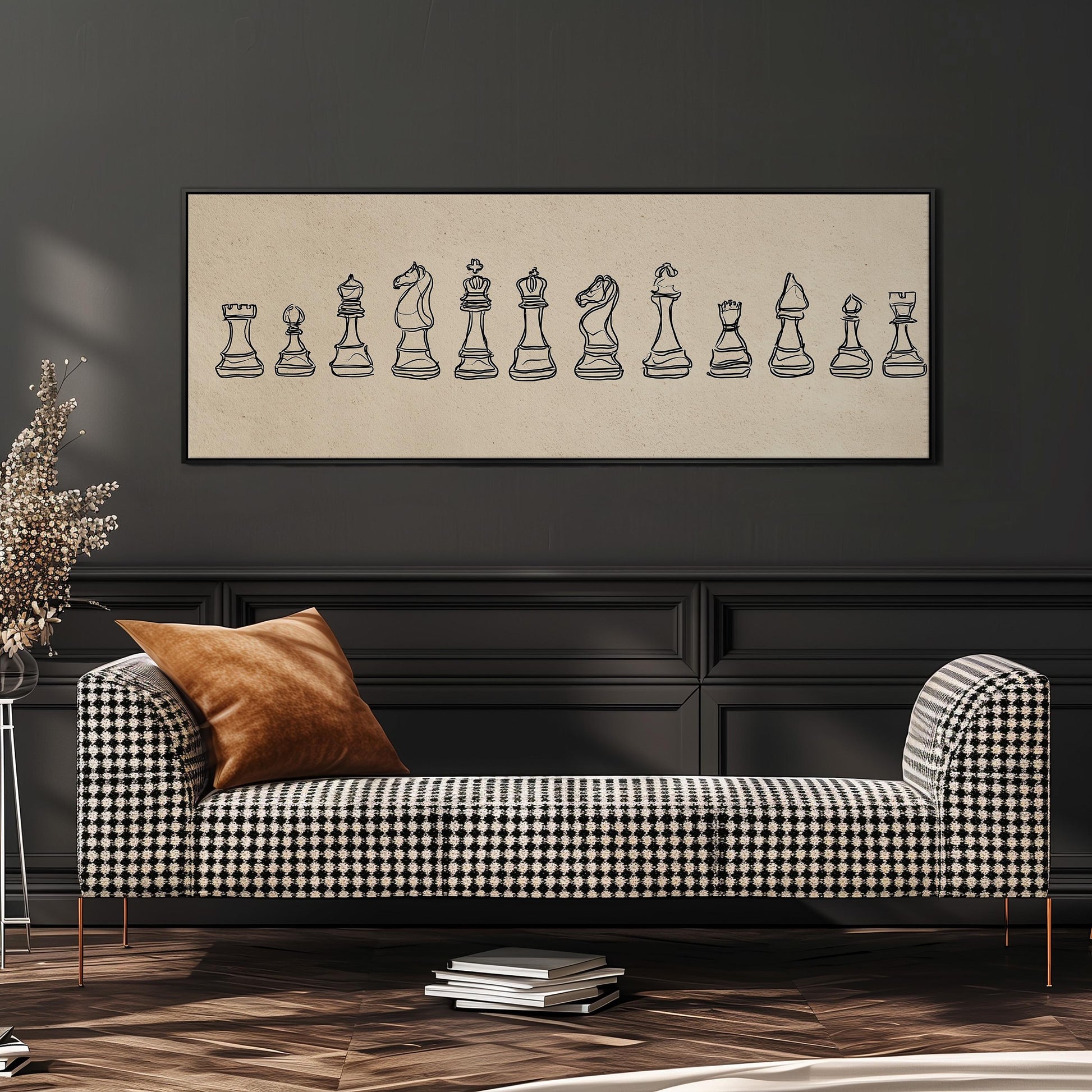 a black and white checkered sofa with a brown throw pillow, set against a dark wall with a framed illustration of chess pieces above it.