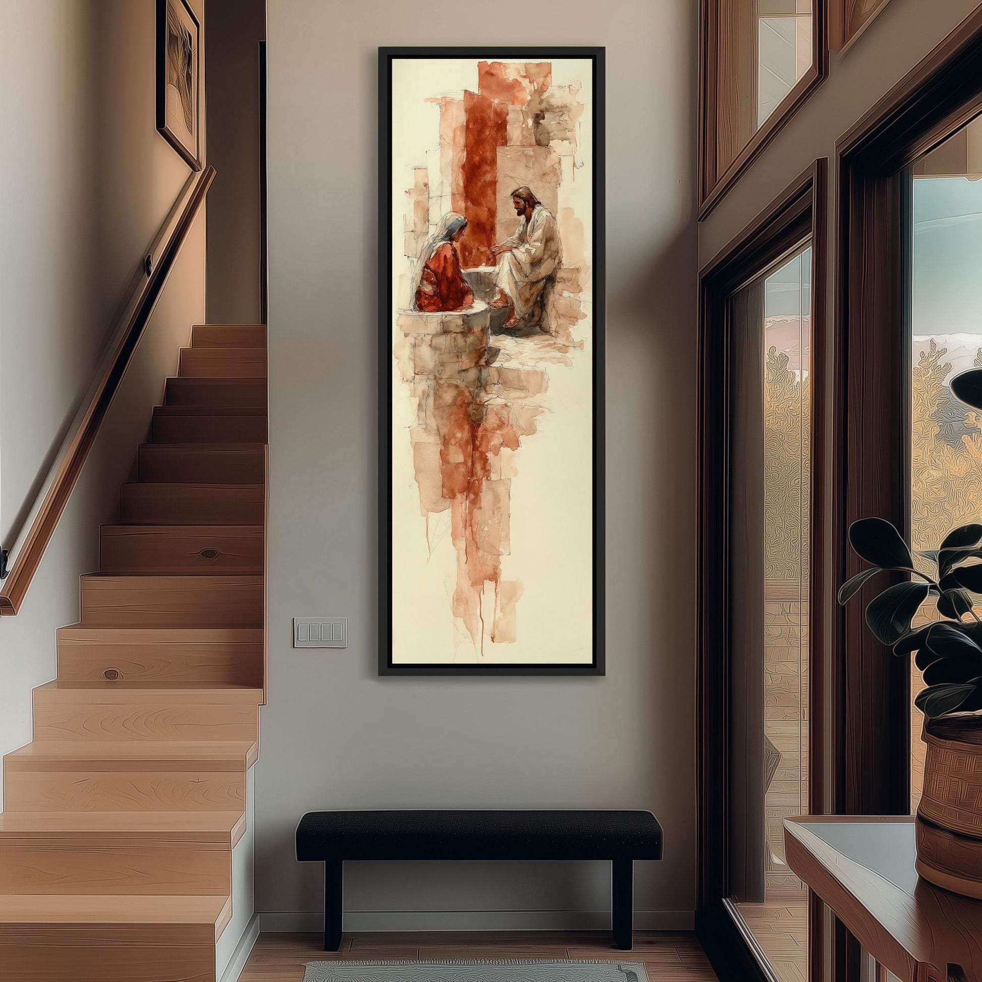 a large, framed painting hanging on a wall in a hallway. The painting depicts a man and a woman sitting together, with the man appearing to be in a kneeling position. The painting is the central focus of the hallway, which also includes a staircase, a bench, and a potted plant.
