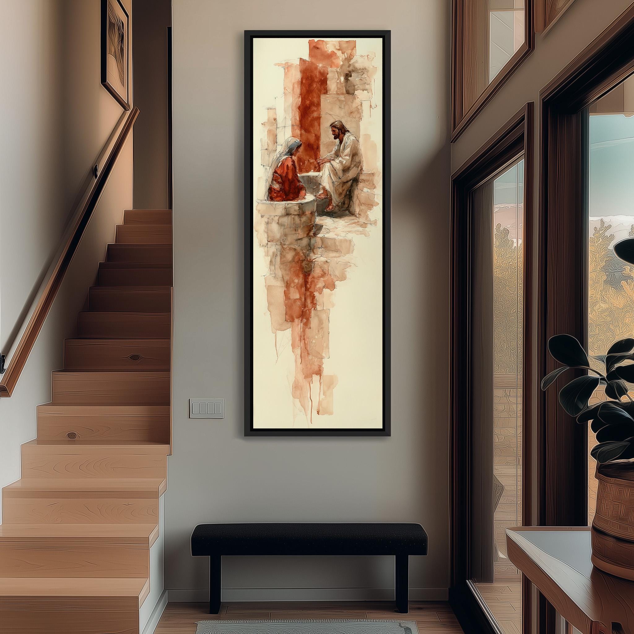 a large, framed painting hanging on a wall in a hallway. The painting depicts a man and a woman sitting together, with the man appearing to be in a kneeling position. The painting is the central focus of the hallway, which also includes a staircase, a bench, and a potted plant.