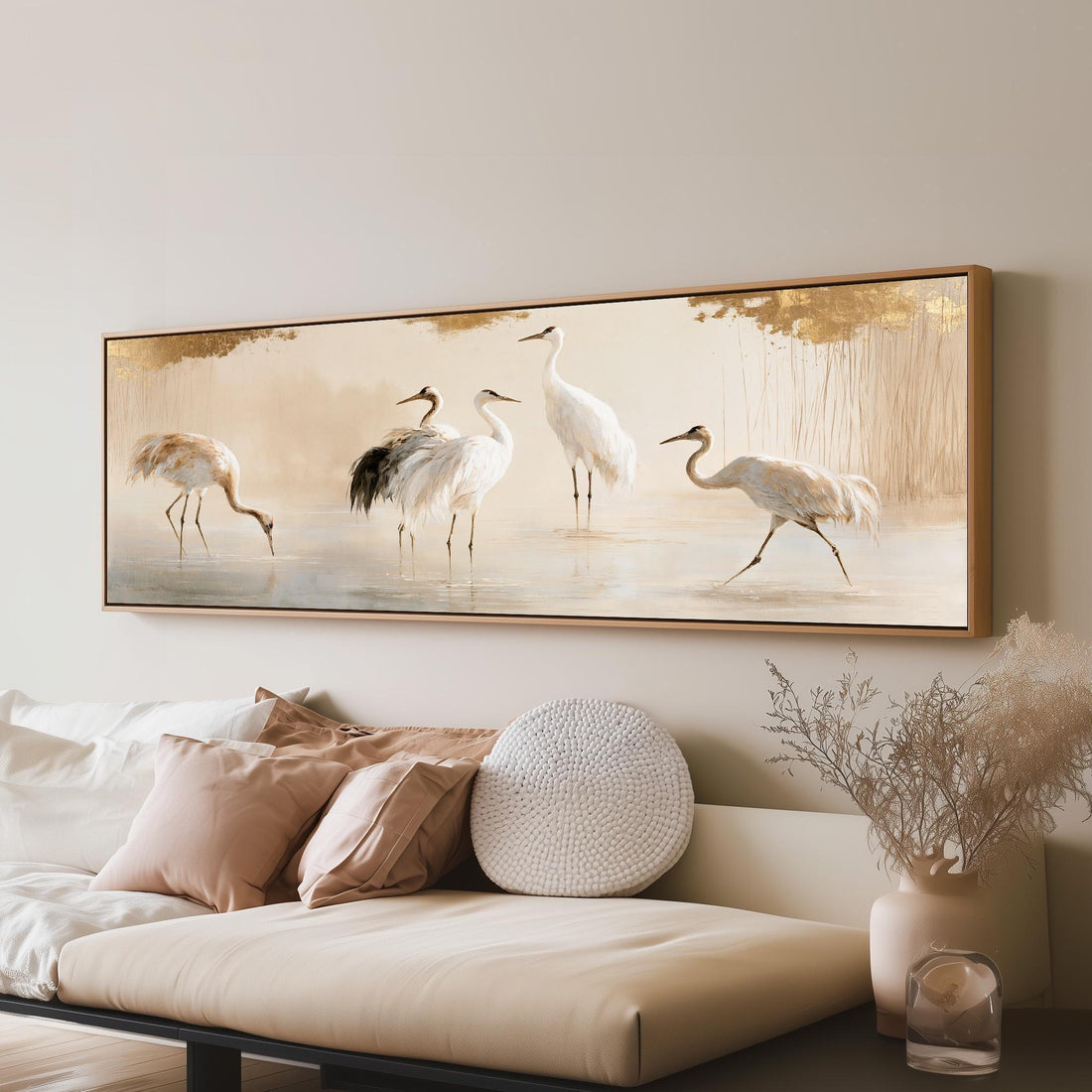 Group of cranes wading in soft light long horizontal canvas print above a sofa in a living room
