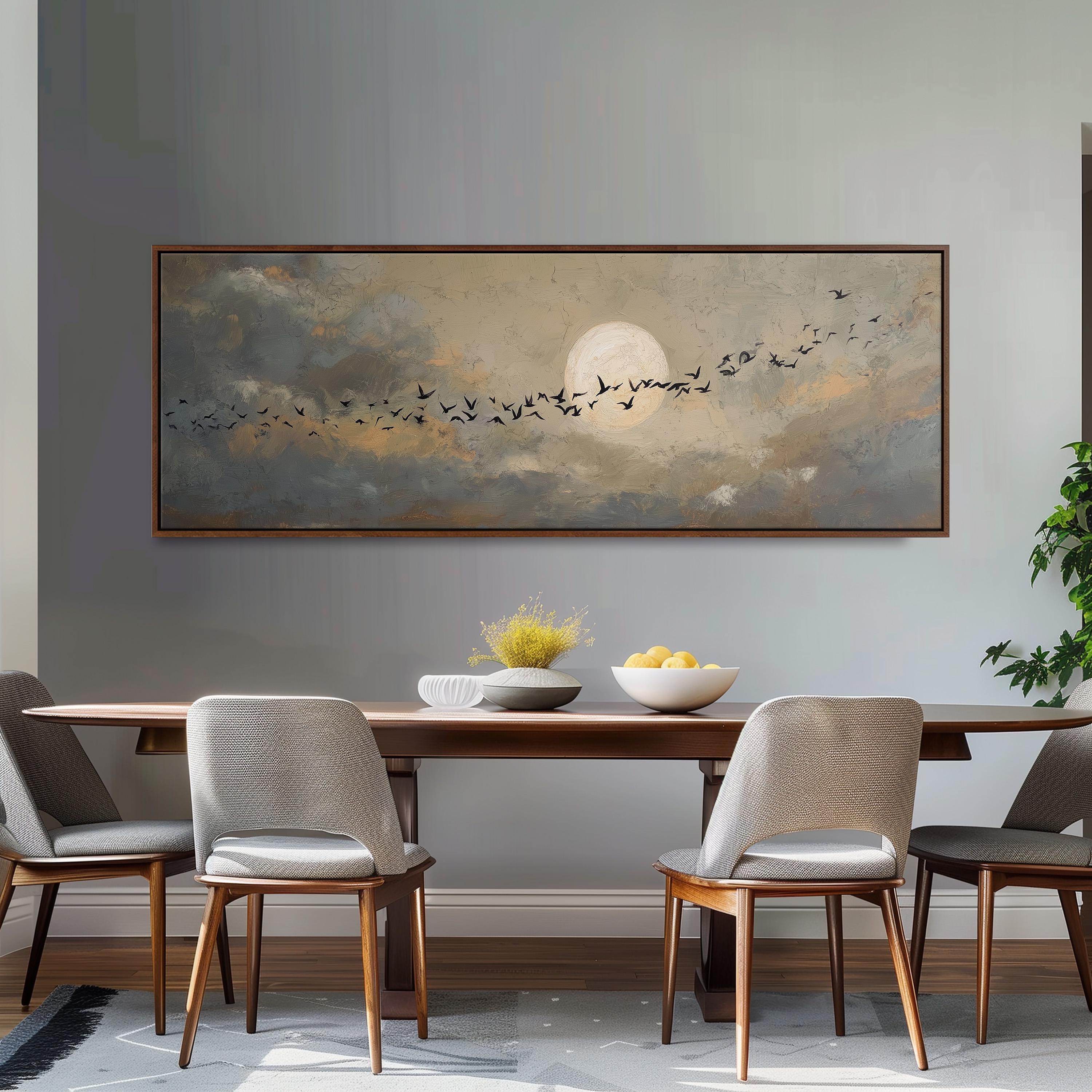a dining room with a large painting of a flock of birds flying across a cloudy sky above a bowl of fruit on a wooden table.