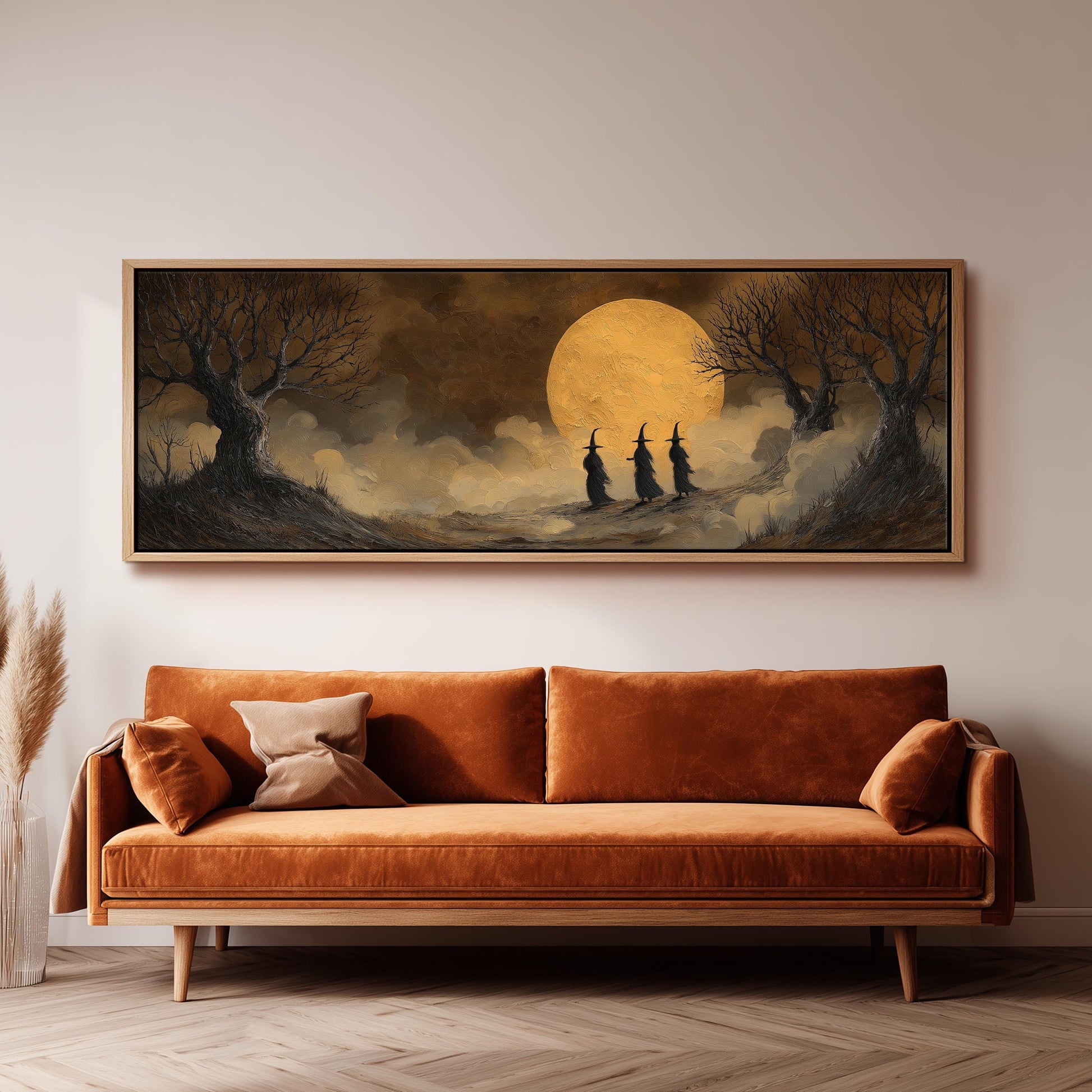 a large, framed painting of a nighttime landscape with a full moon, trees, and three people dressed in black hats walking through the mist.