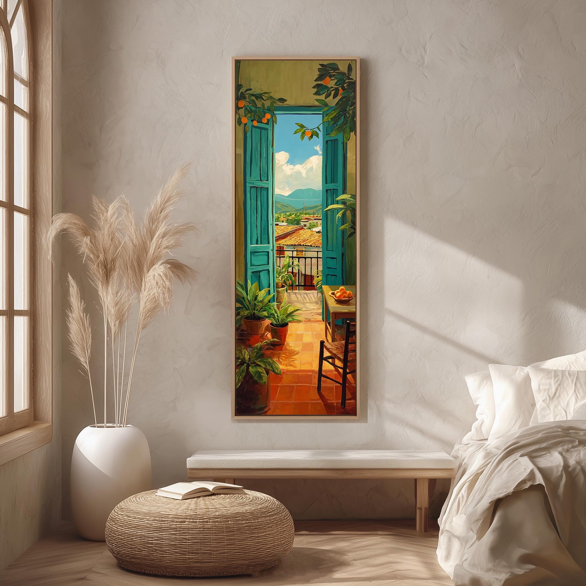 a large painting of a balcony scene hanging on a wall, with a view of a terrace and a table with chairs. The painting is surrounded by various decorative elements, including a potted plant, a woven ottoman, and a white vase.