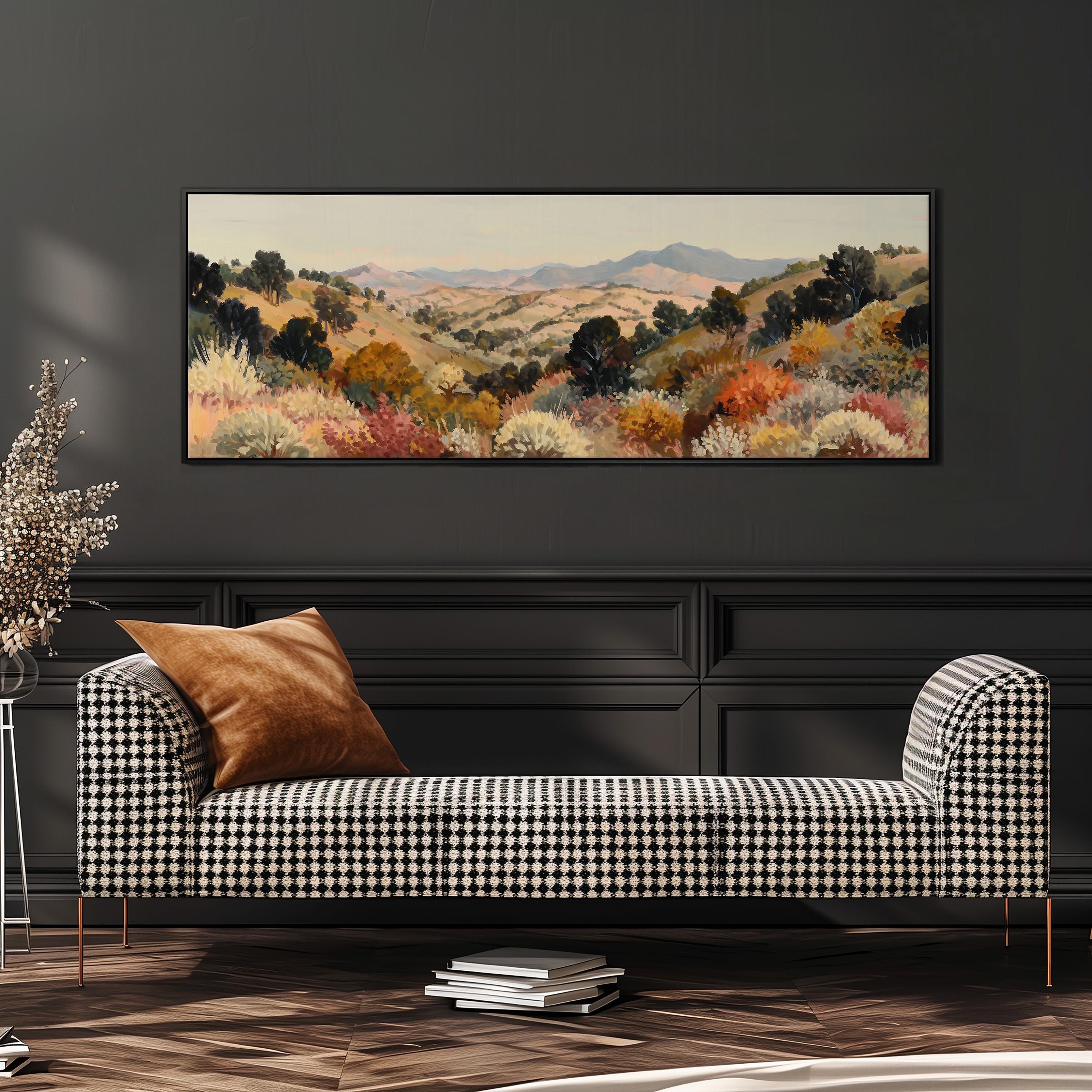a large, rectangular painting of a countryside landscape hanging on a wall above a black and white checkered sofa.