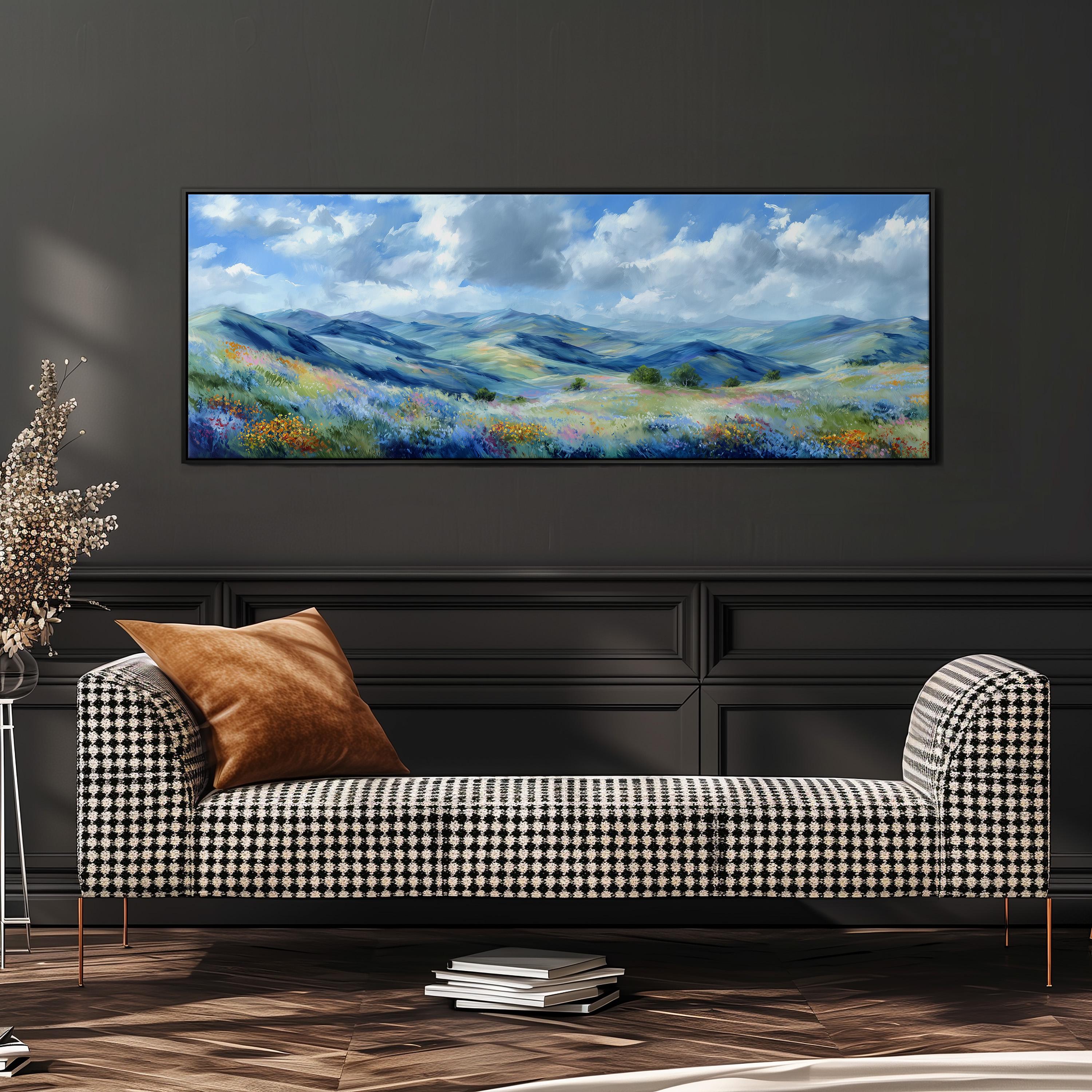 a large landscape painting hanging on a wall above a black and white checkered sofa with a brown throw pillow.
