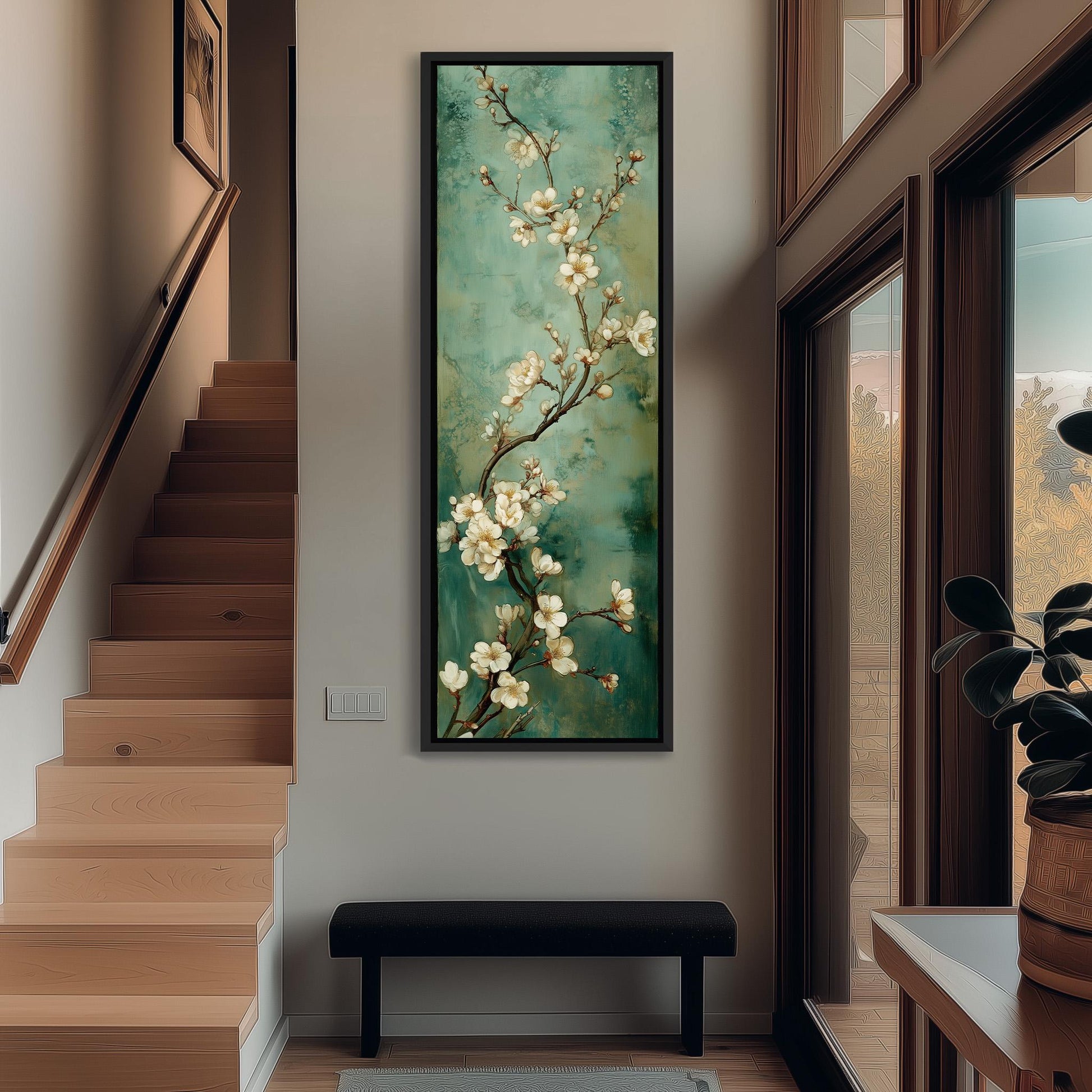 a hallway with a large painting of white flowers hanging on the wall. The painting is framed and appears to be a focal point in the space. The hallway has a wooden staircase and a bench, creating a cozy and inviting atmosphere.