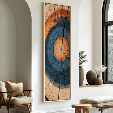Blue and orange tree ring long vertical canvas print in a sunlit living space
