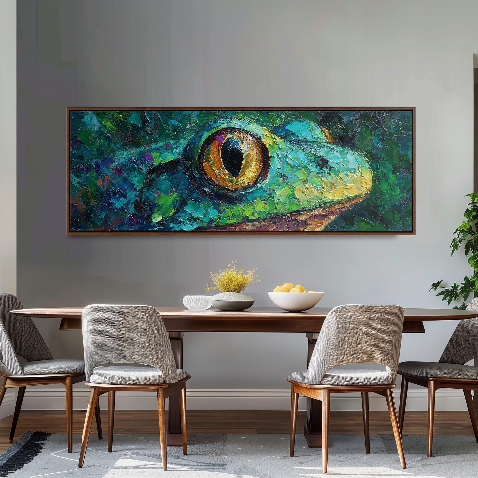 a large painting of a frog's face hanging on a wall above a wooden dining table with four chairs.