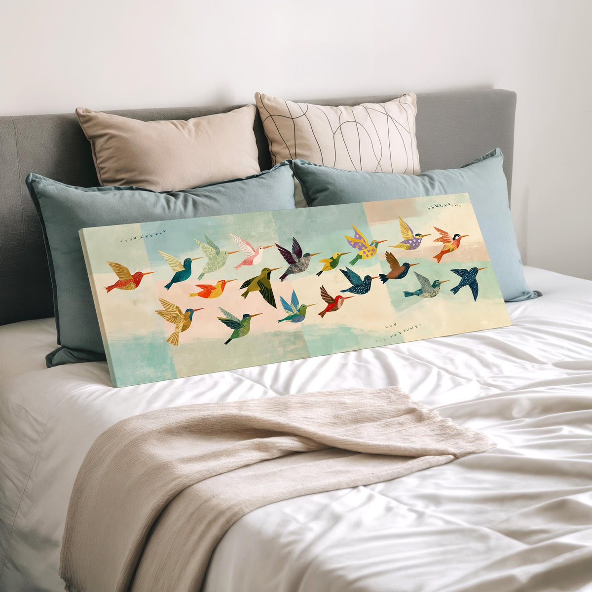 Flock of colorful hummingbirds wide panoramic canvas print laid on a bed to show its size
