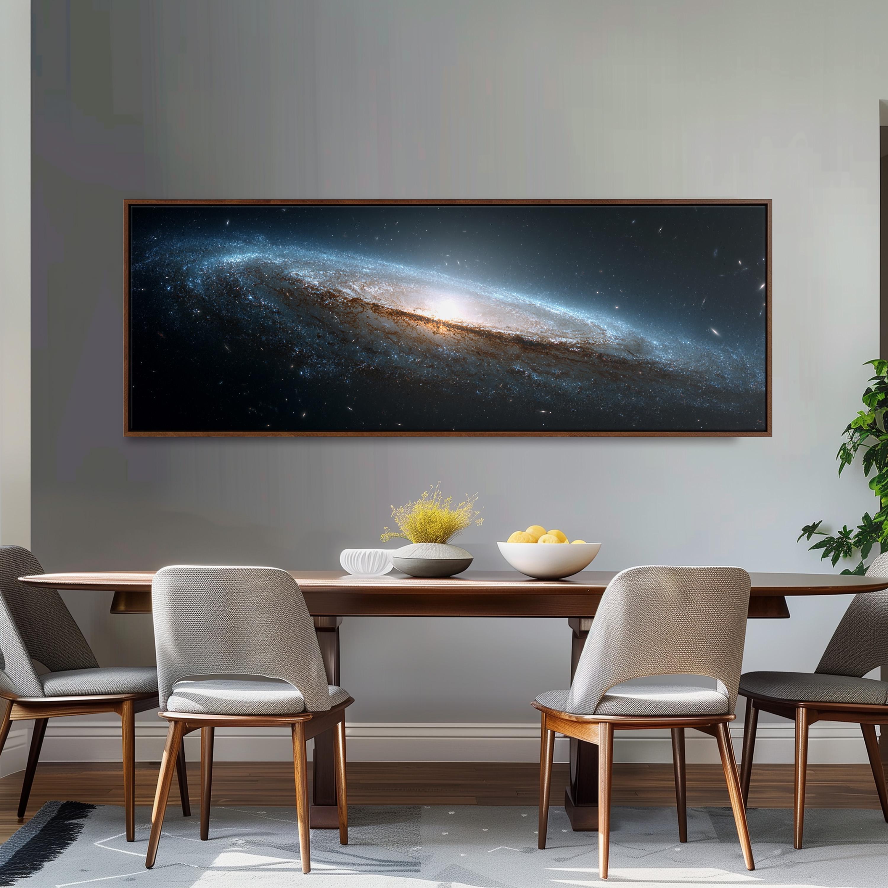 a large, framed picture of a galaxy hanging on a wall above a wooden dining table with four chairs. The table is set with a bowl of fruit and a vase of flowers, creating a cozy and inviting atmosphere.