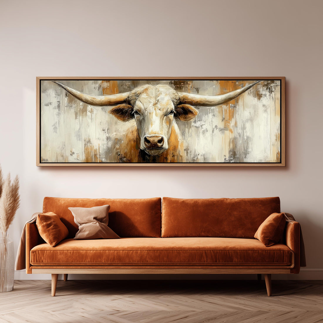 a large painting of a bull's head hanging on a wall above a brown sofa.