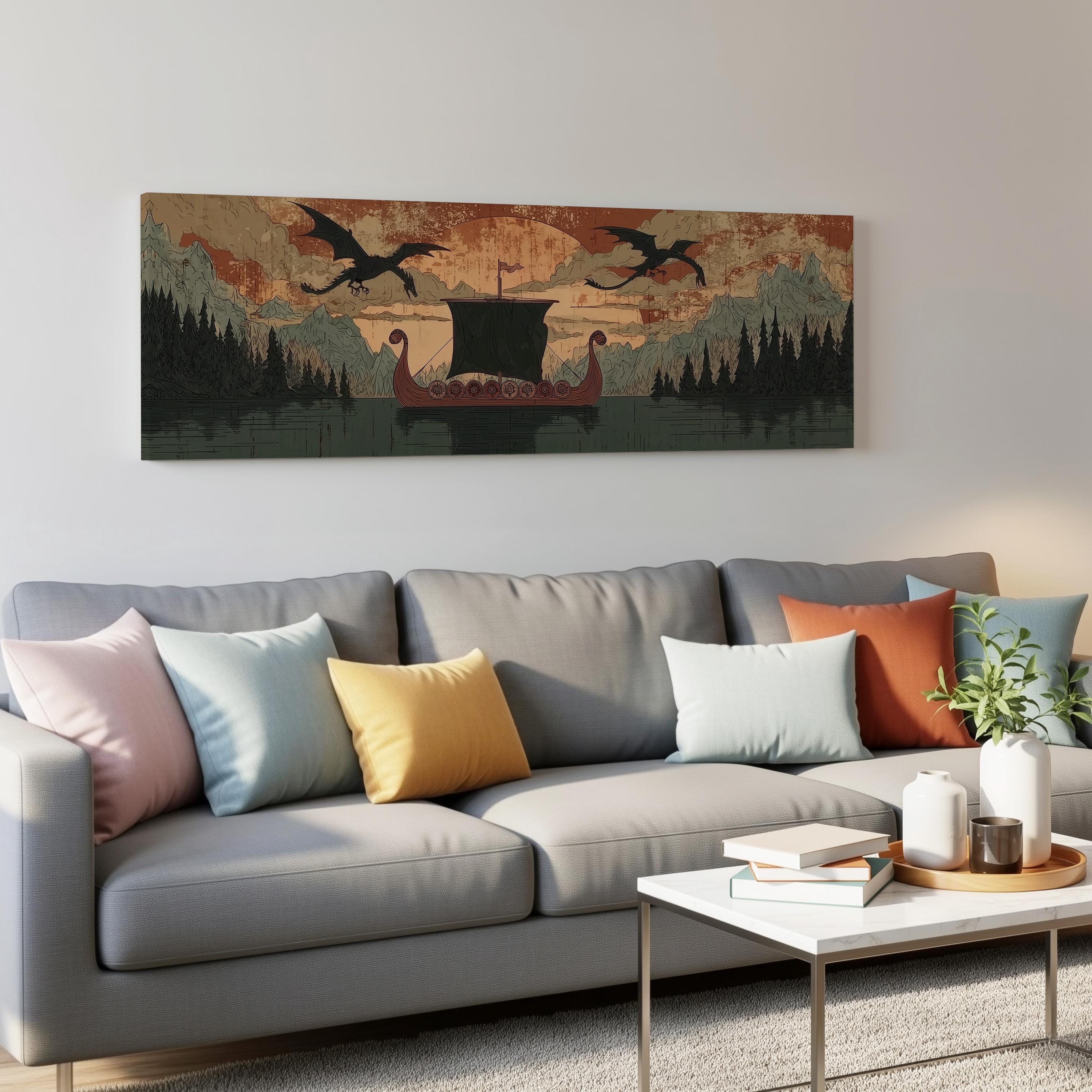 a large canvas print depicting a boat sailing on a lake, with mountains in the background and two dragons flying above it. The print is hanging on a wall above a gray couch, which is adorned with colorful throw pillows. In front of the couch, there is a coffee table with a stack of books and a vase with flowers.