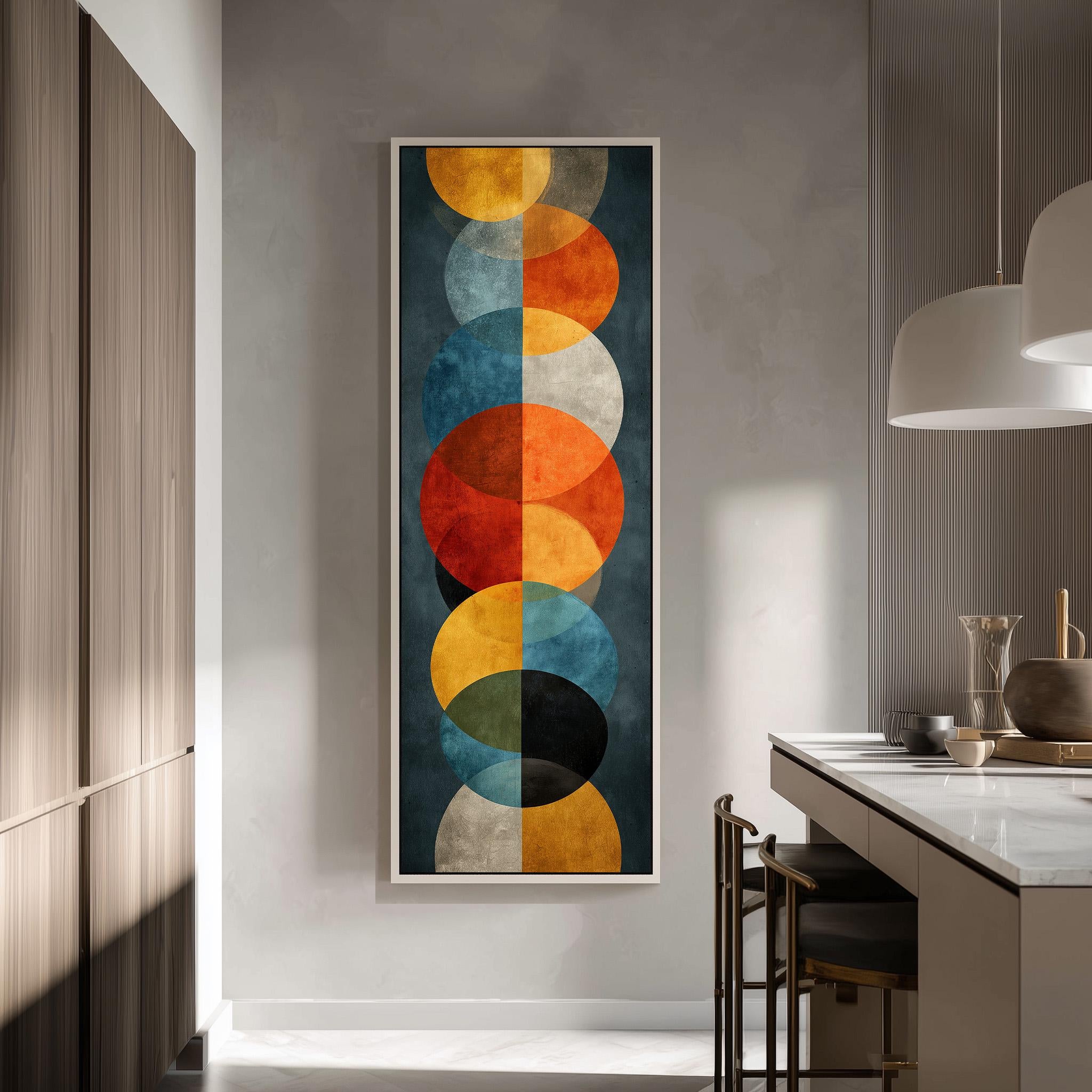 a modern kitchen with a large abstract painting hanging on the wall. The painting consists of a series of circles in various colors, including orange, blue, green, and yellow, creating a vibrant and dynamic visual effect. The kitchen is well-lit, with a countertop and chairs visible, and a pendant light hanging above the countertop, providing additional lighting.