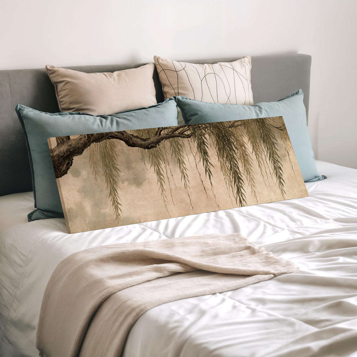Hanging willow branches wide panoramic canvas print laid on a bed to show its size