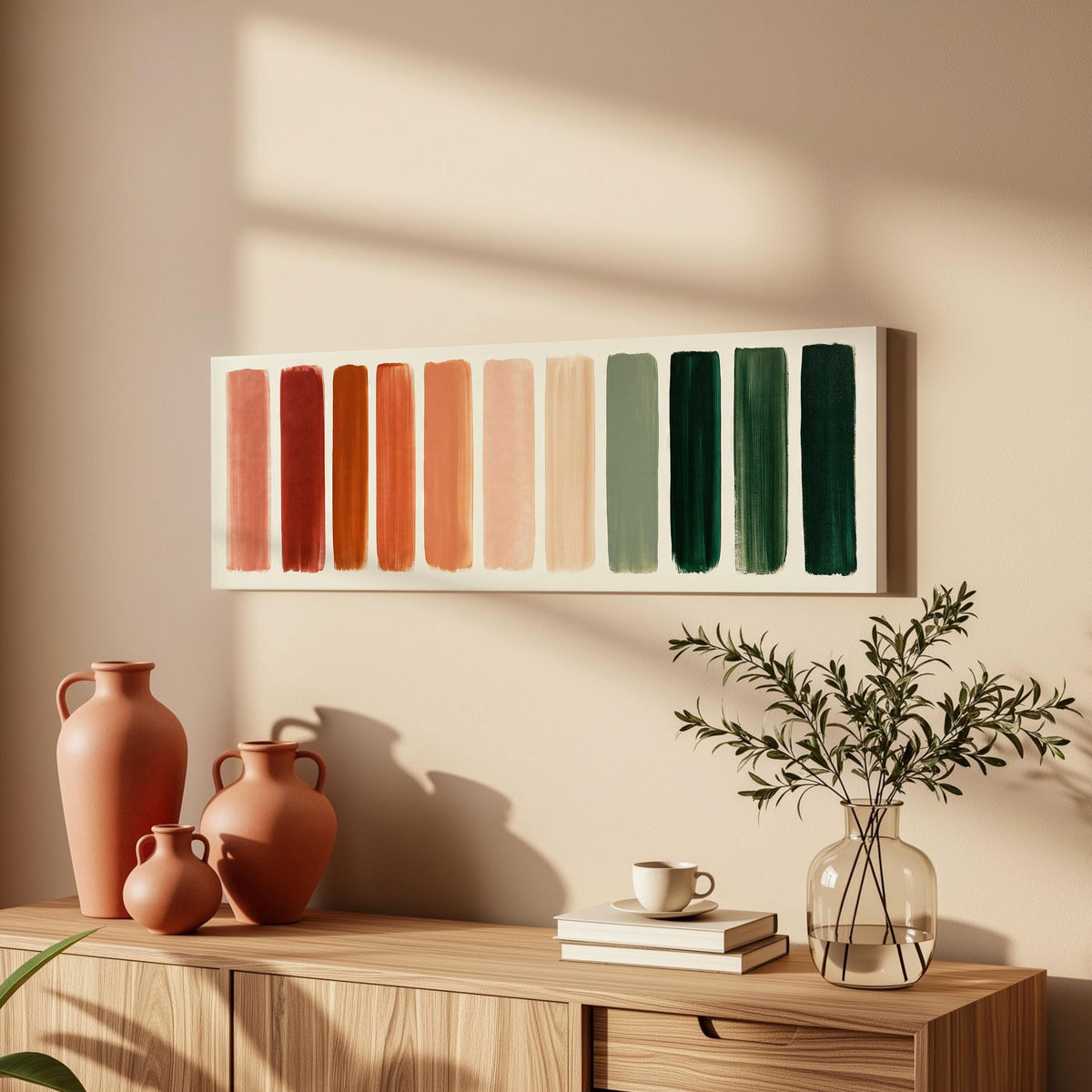 Brushed swatches from terracotta to forest green long horizontal canvas print above a wooden sideboard