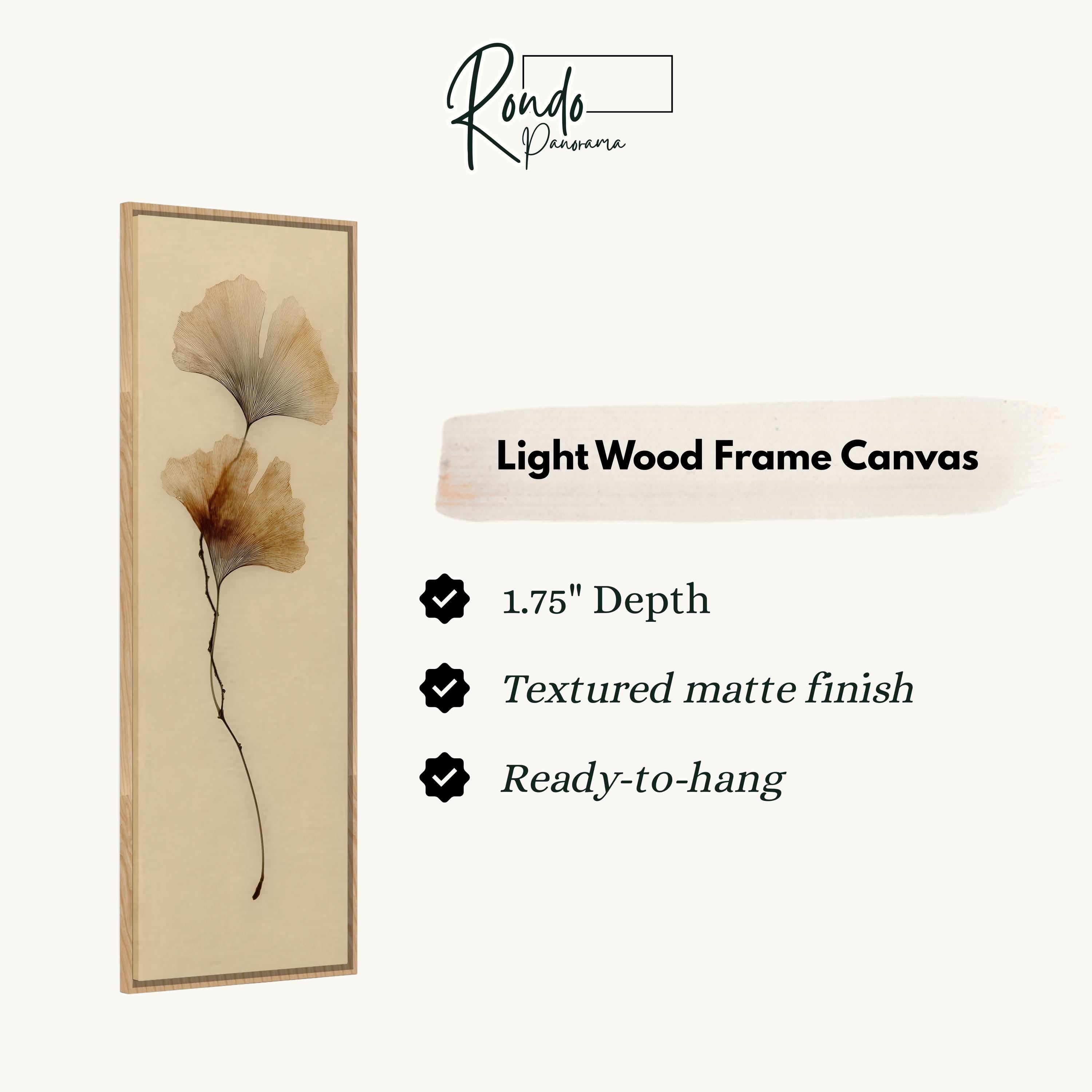 The image is a light wood frame canvas with a single brown leaf on a beige background.