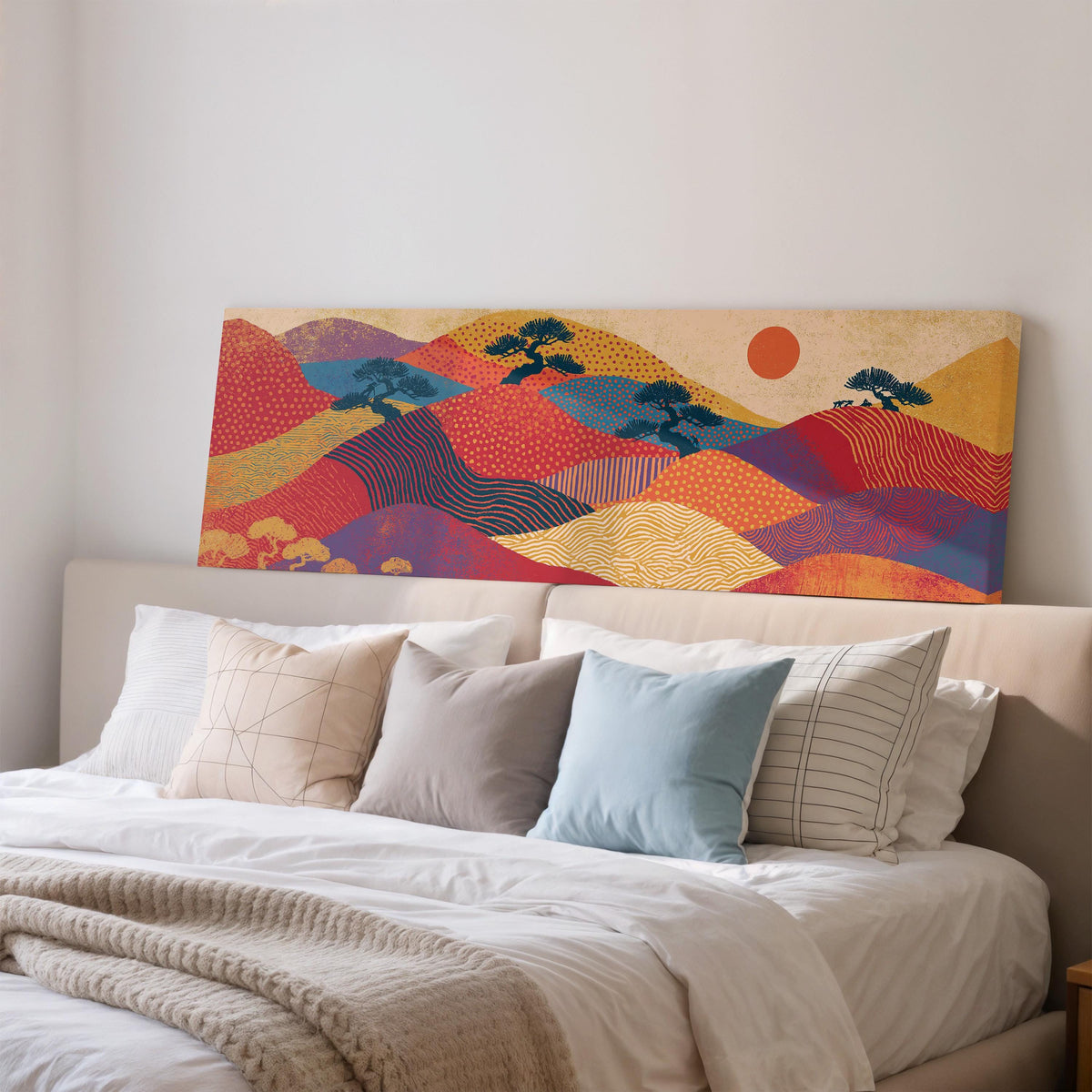 Bonsai trees on patterned hills with a red sun wide panoramic canvas print above a bed in a bedroom