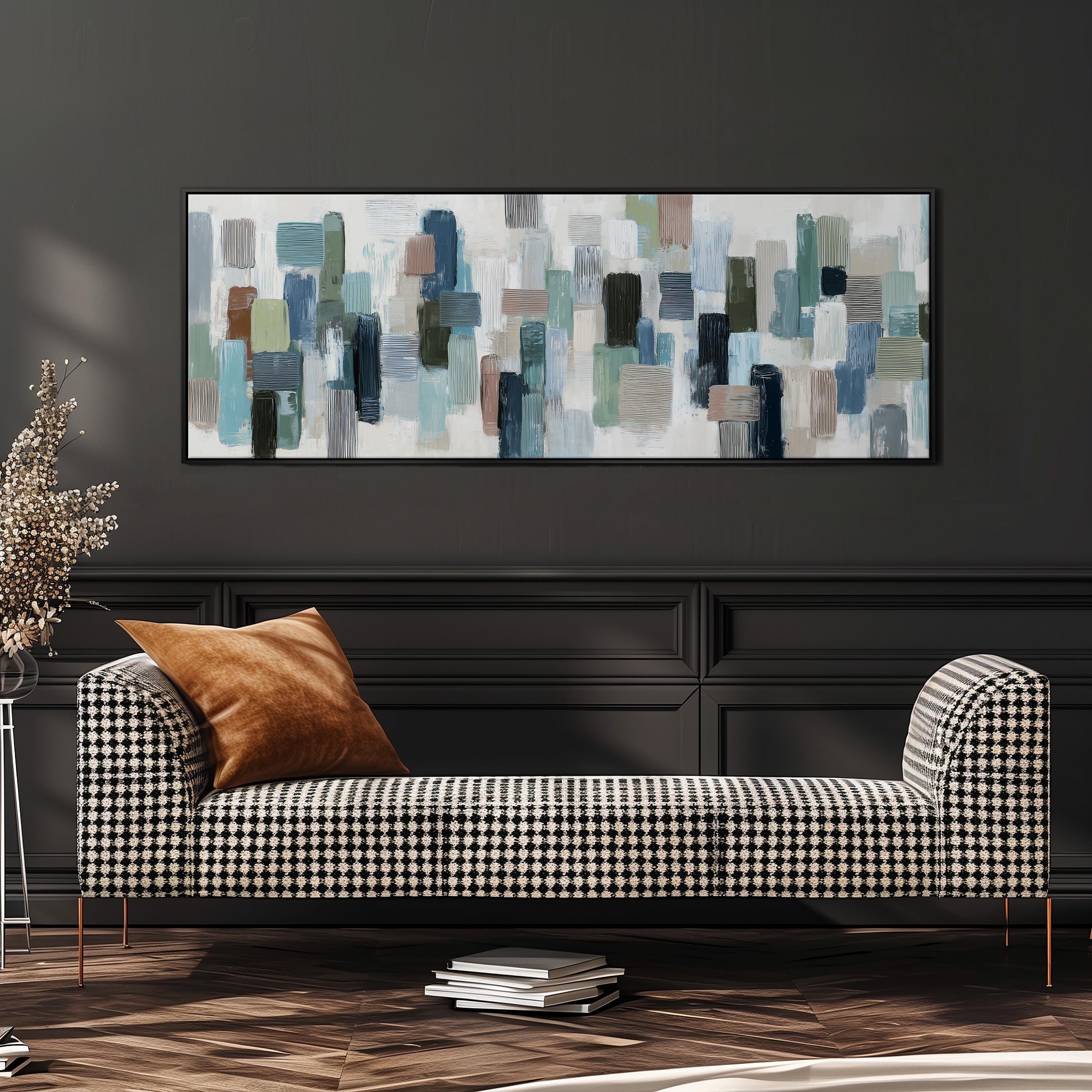 a modern living room with a black and white checkered sofa, a large abstract painting on the wall, and a stack of books on the floor.