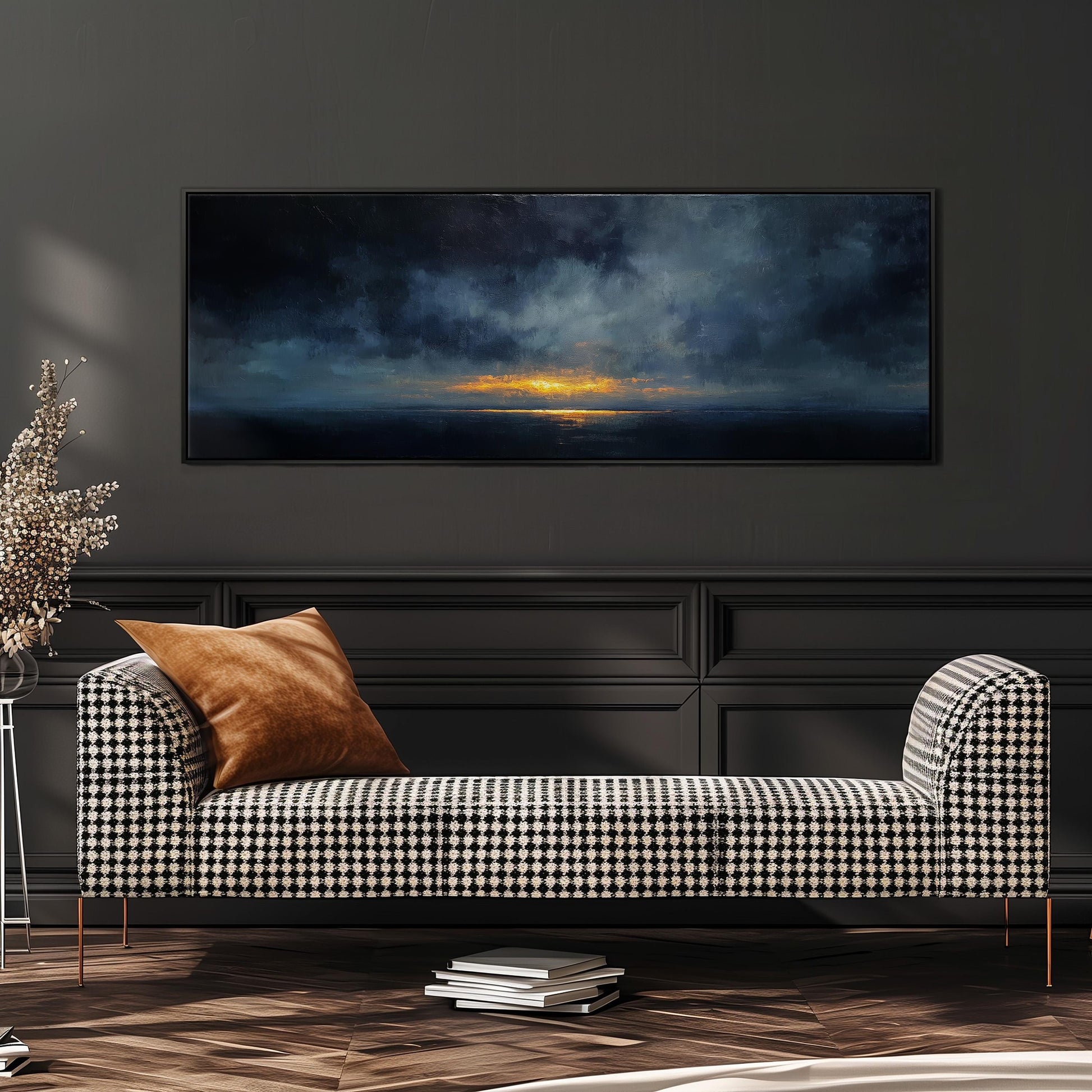 a large black and white checkered sofa with a brown throw pillow, positioned in front of a dark wall with a framed painting depicting a sunset over the ocean.