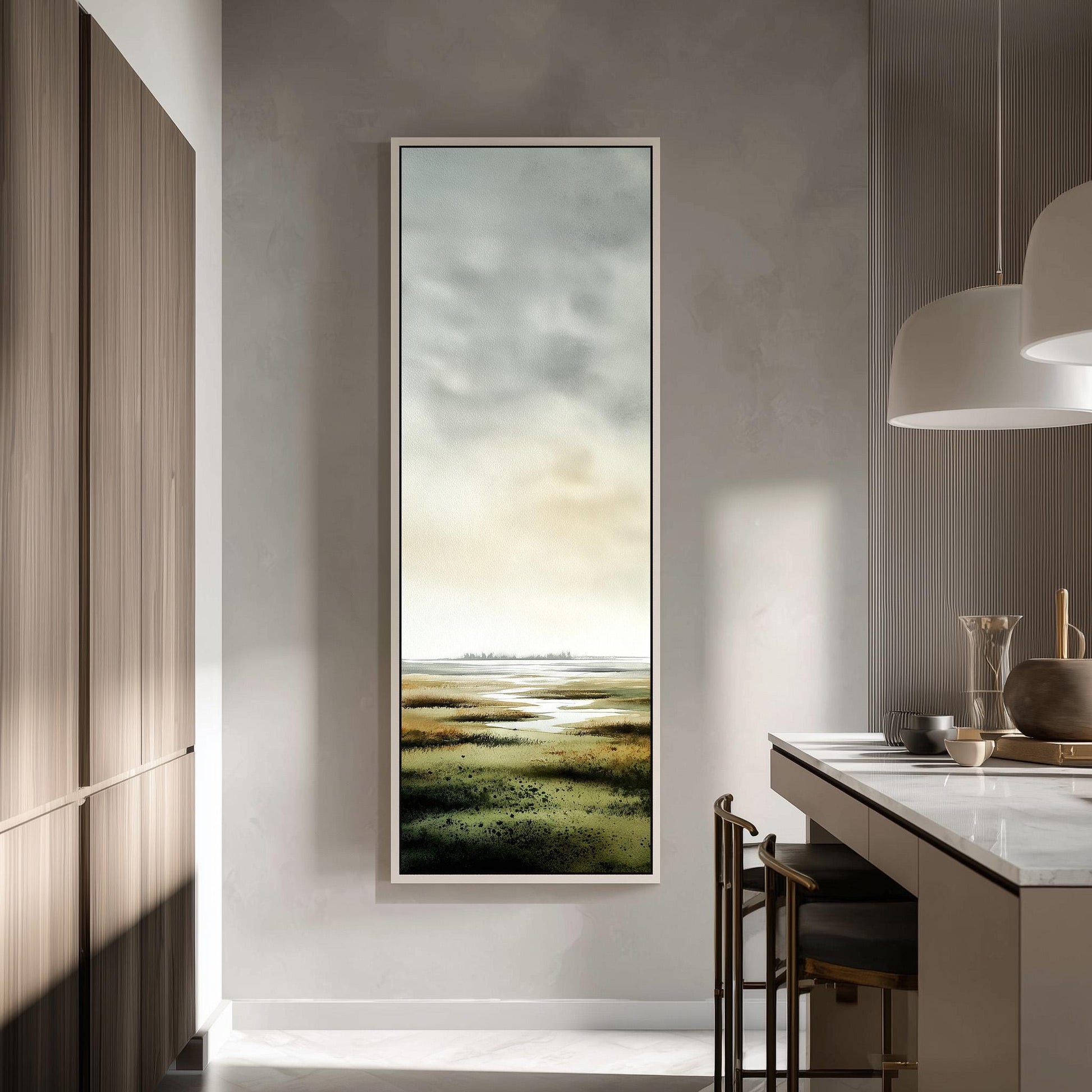 a modern kitchen with a large window that provides a view of a grassy field. The kitchen has a minimalist design with a white countertop and wooden cabinets. There is a painting hanging on the wall, adding an artistic touch to the space.