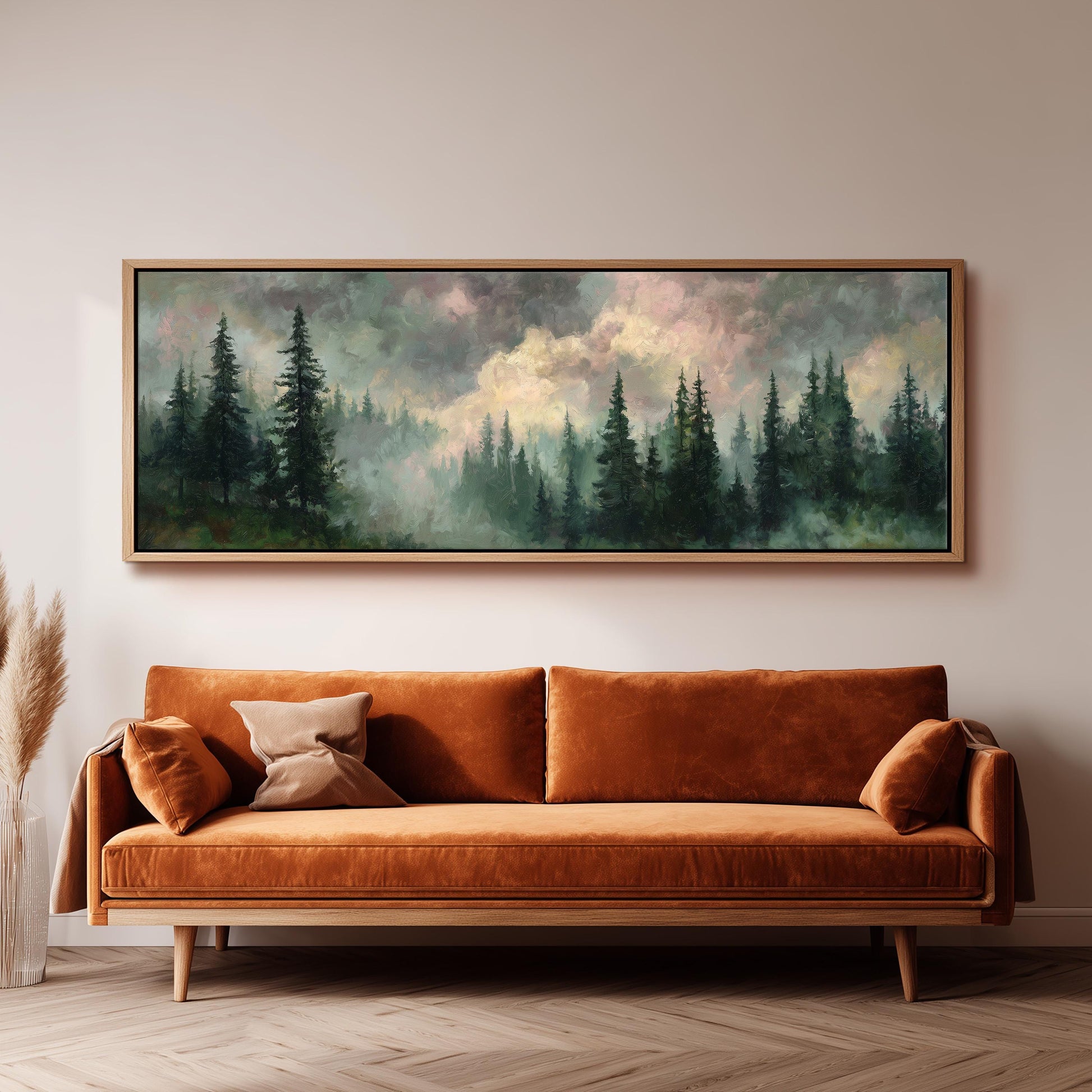 a large painting of a forest scene hanging on a wall above a brown sofa with orange cushions.