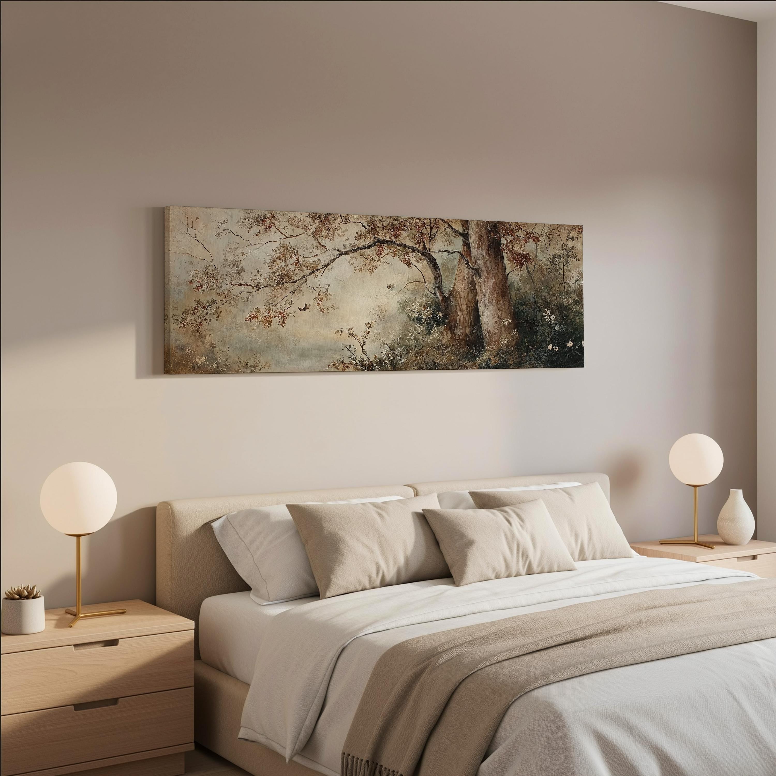 a serene bedroom scene with a large bed adorned with white linens and beige throw pillows. Above the bed, a painting of a tree with a brown trunk and branches is displayed on the wall. The room is decorated with two round table lamps on nightstands, and the overall color scheme is neutral, creating a calm and peaceful atmosphere.