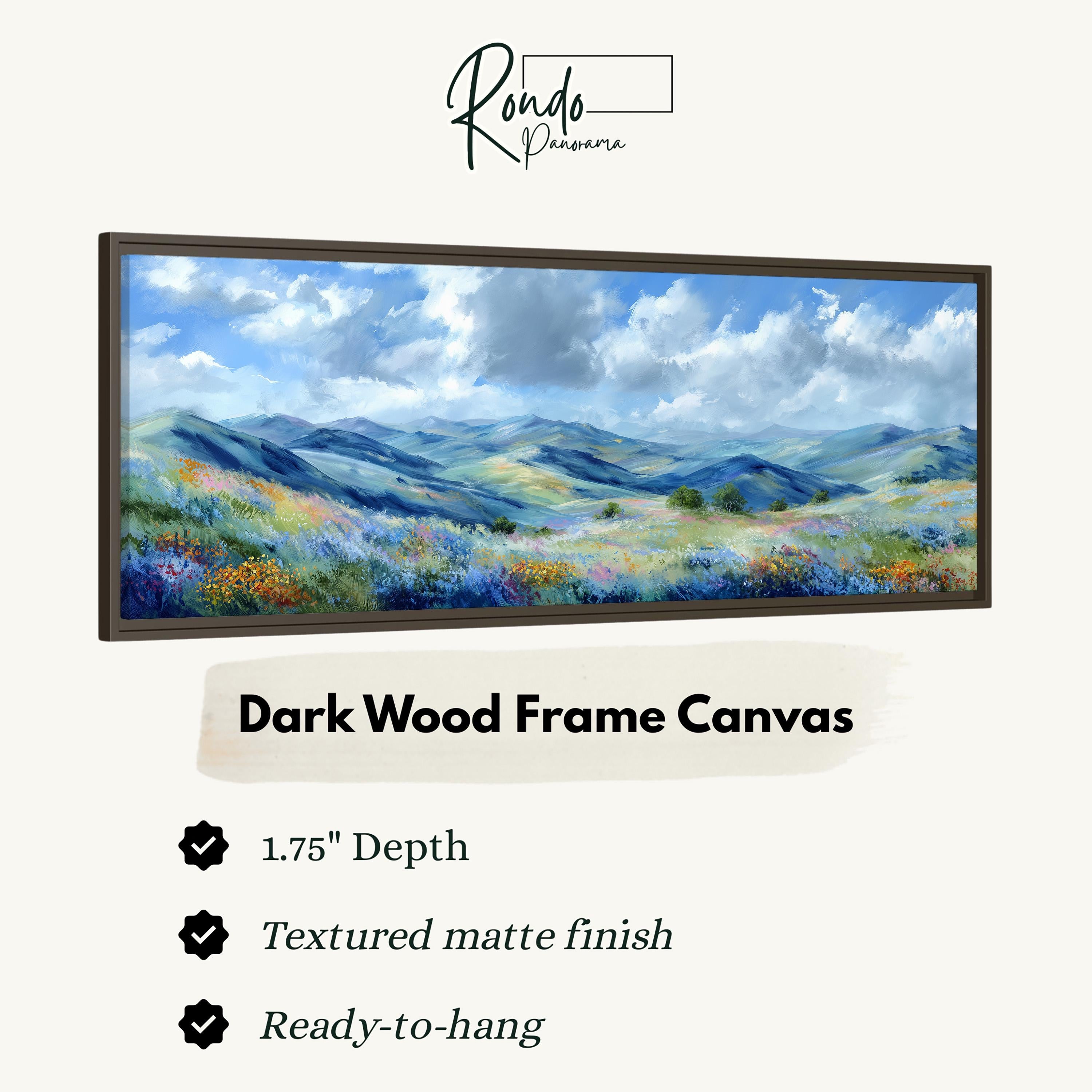 The image is a framed painting of a landscape with mountains and a field of flowers.