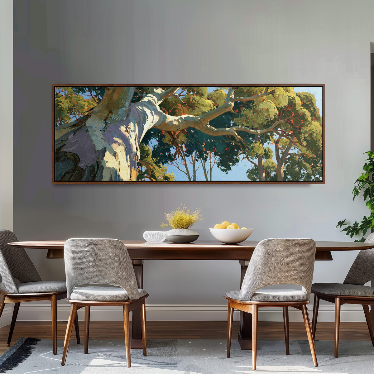Sunlit eucalyptus trunk and branches long horizontal canvas print above a dining table