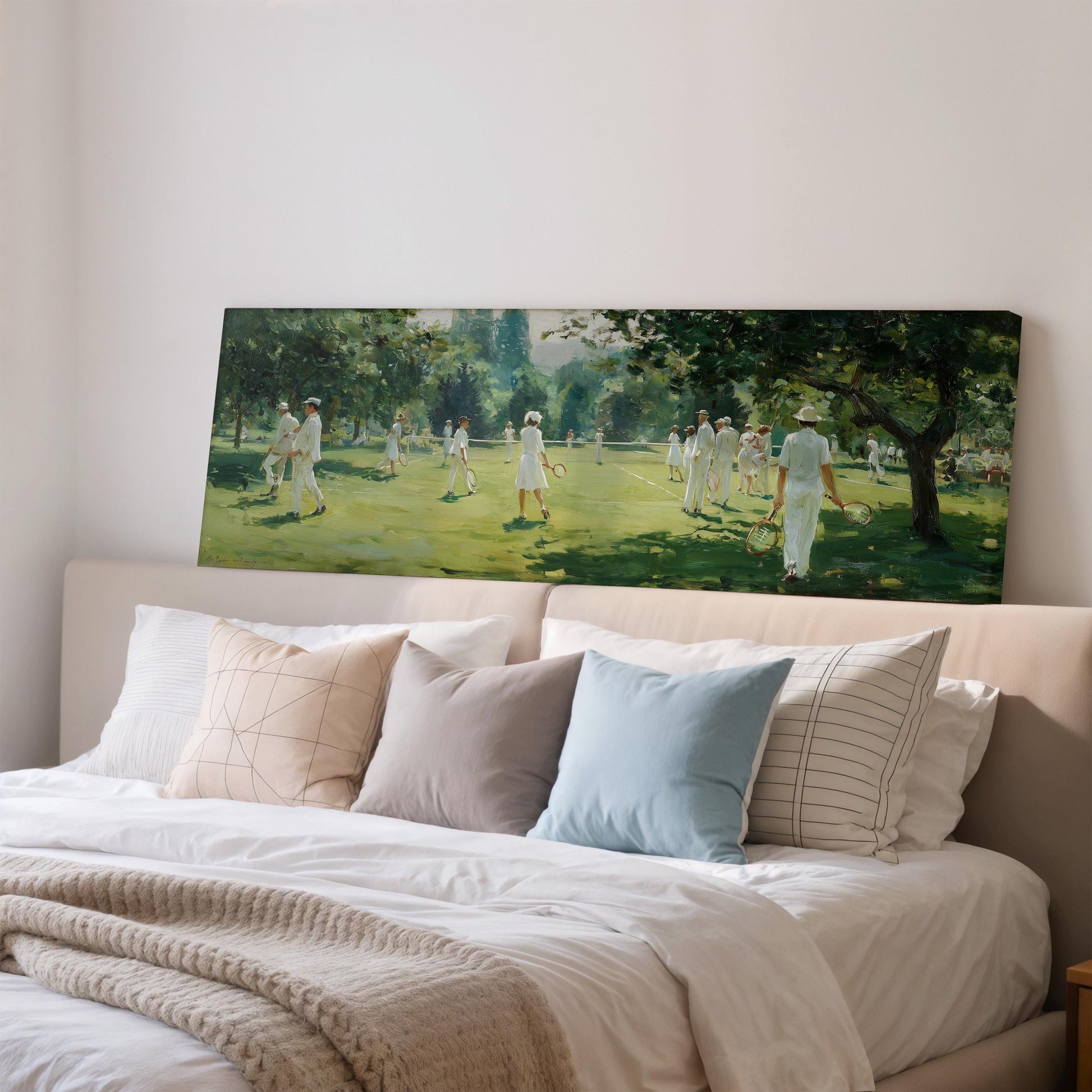 a large painting of a tennis match on a wall above a bed with white pillows and a gray blanket.
