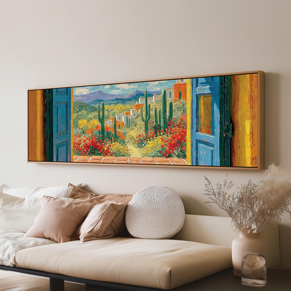 Cactus courtyard seen through blue doors panoramic canvas print above a sofa in a living room