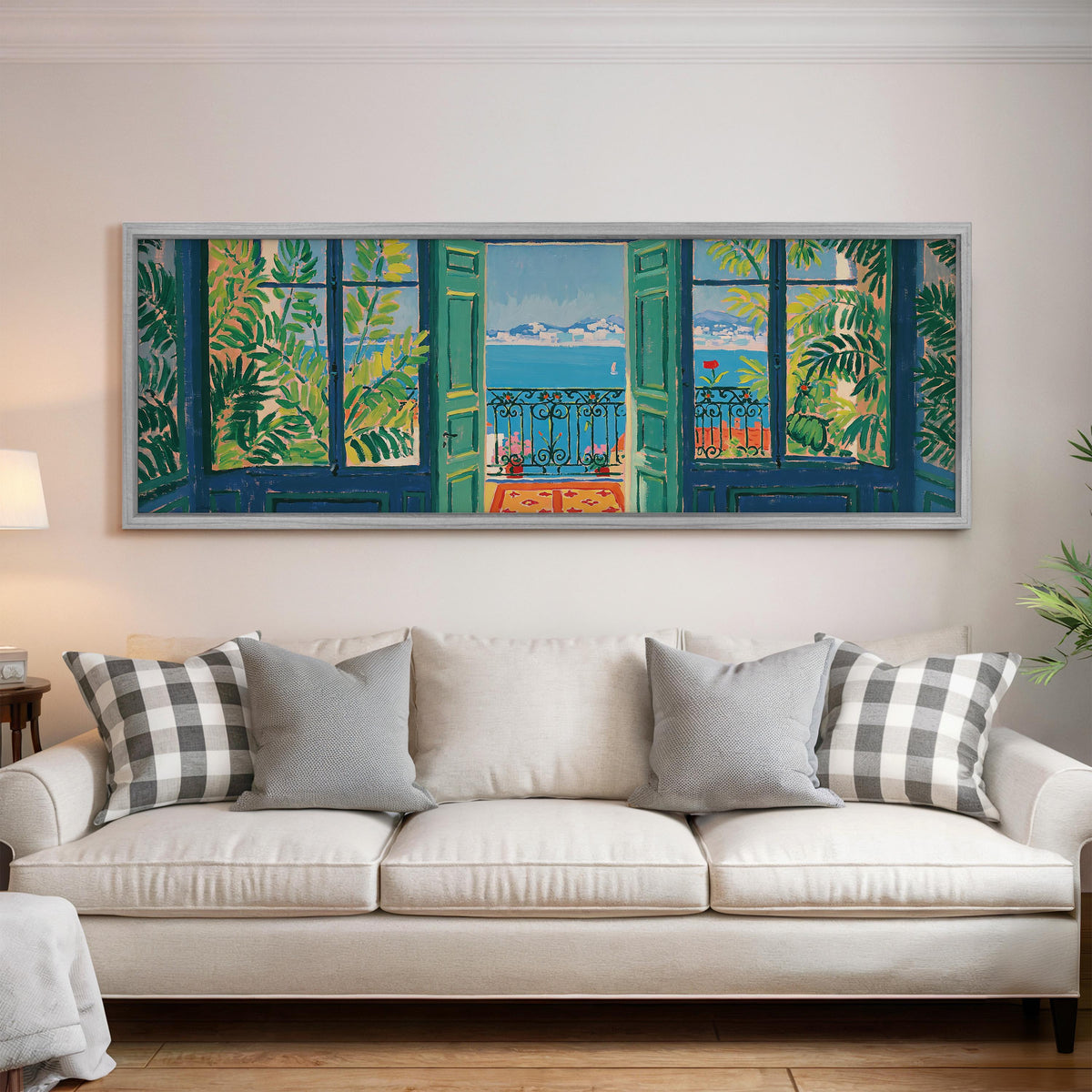 Riviera balcony view through open windows panoramic canvas print above a white sofa in a bright living room