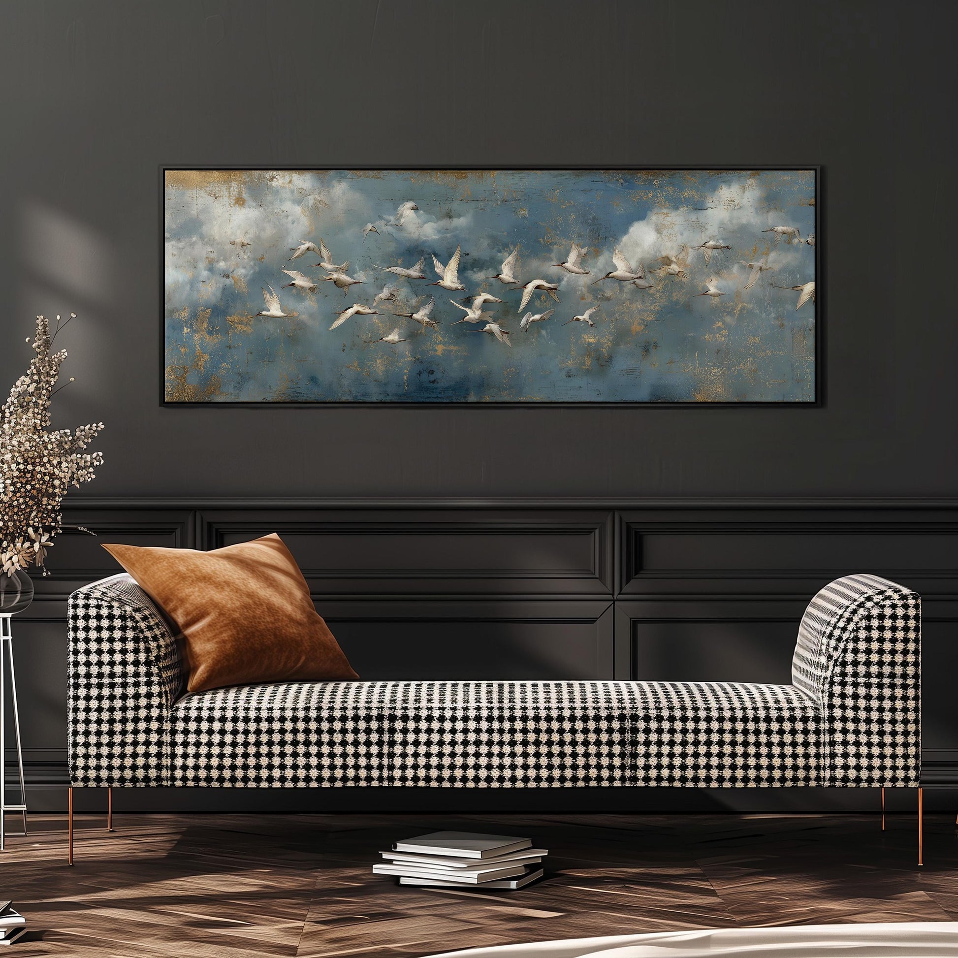 a black and white checkered sofa with a brown throw pillow, set against a dark wall with a large framed painting of birds in the sky above it.