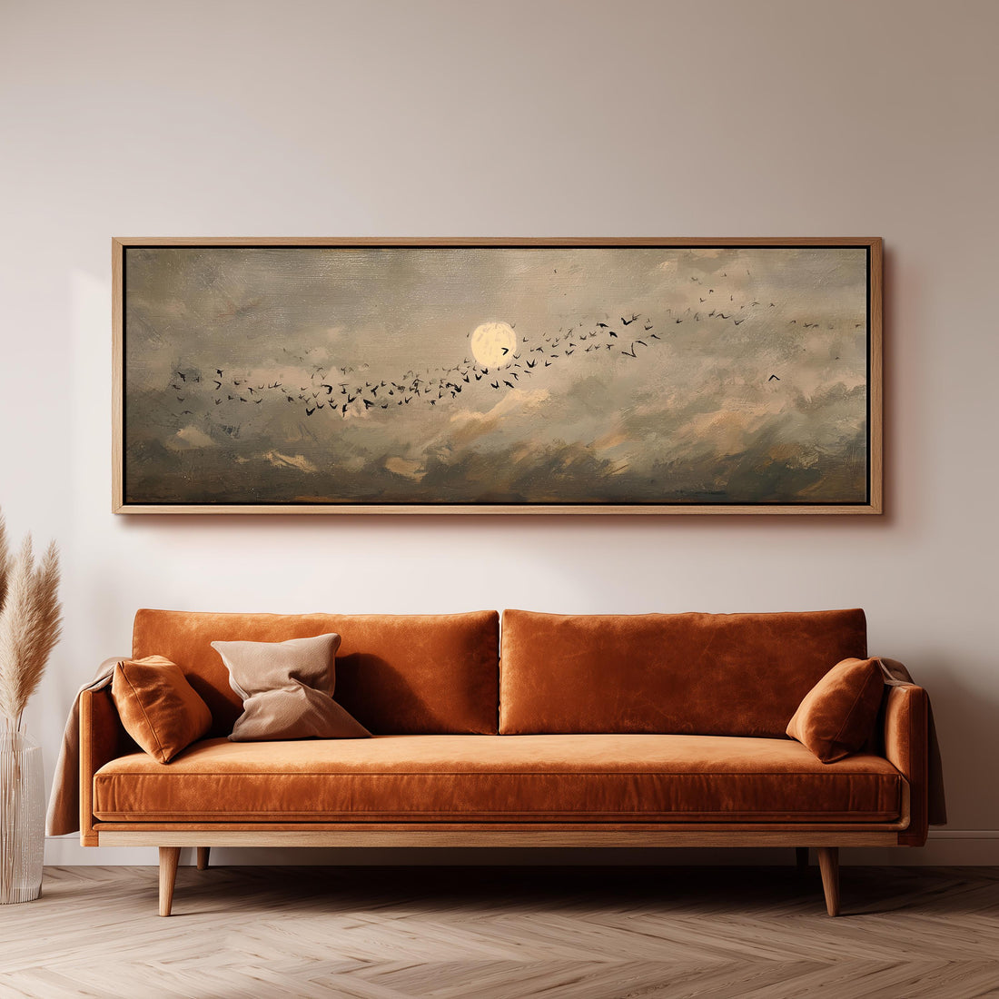 a dining room with a large painting of a flock of birds in the sky above a wooden table. The table is set with a bowl of fruit and a vase of flowers, creating a cozy and inviting atmosphere.