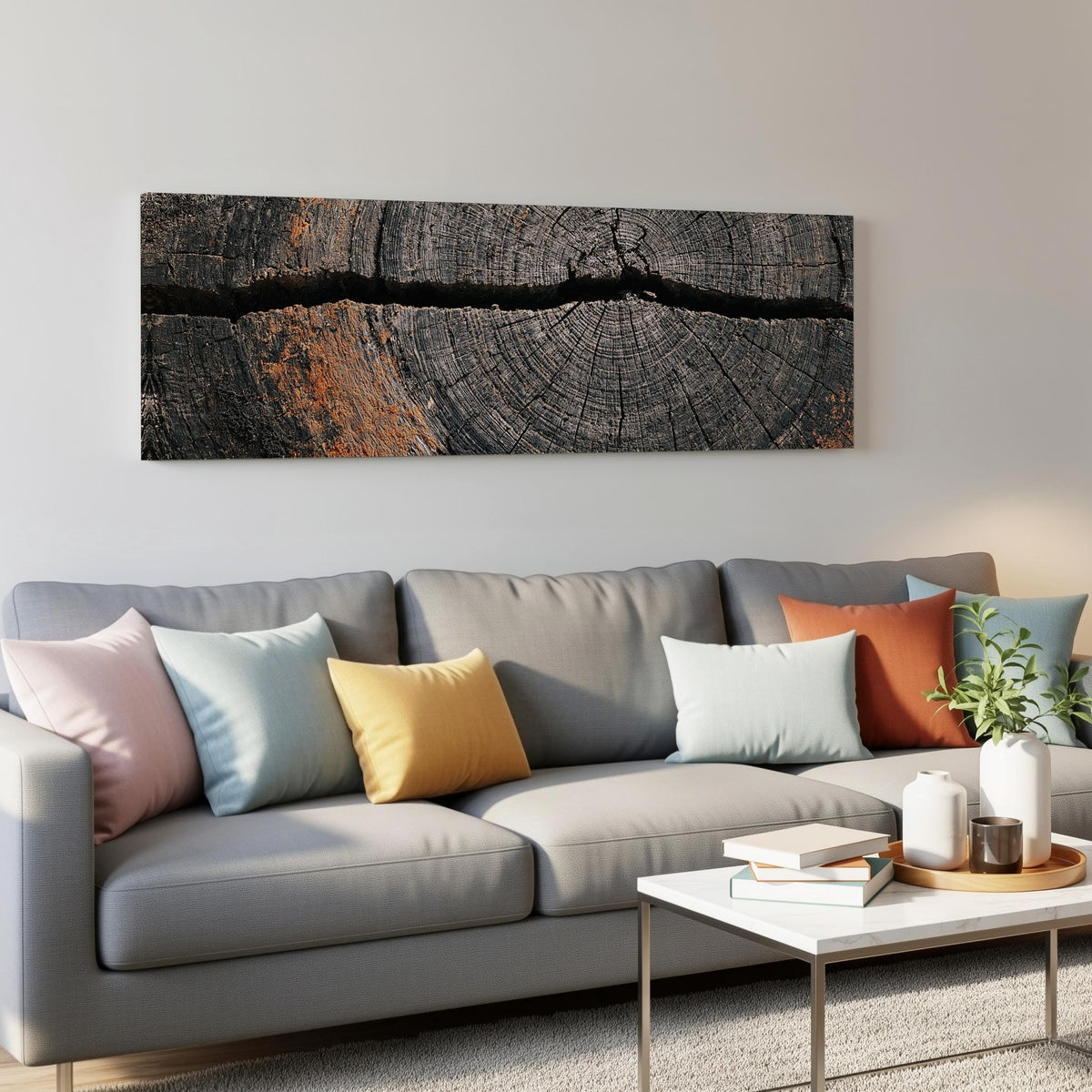 Cracked weathered wood ring panoramic canvas print above a grey sofa in a living room