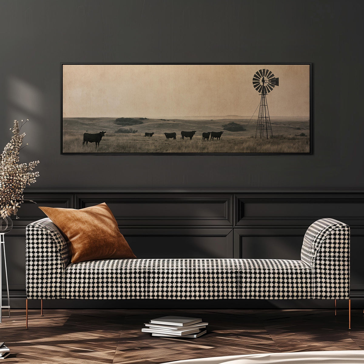 Black cattle grazing by a windmill on the prairie wide panoramic canvas print above a bench in a dark living room