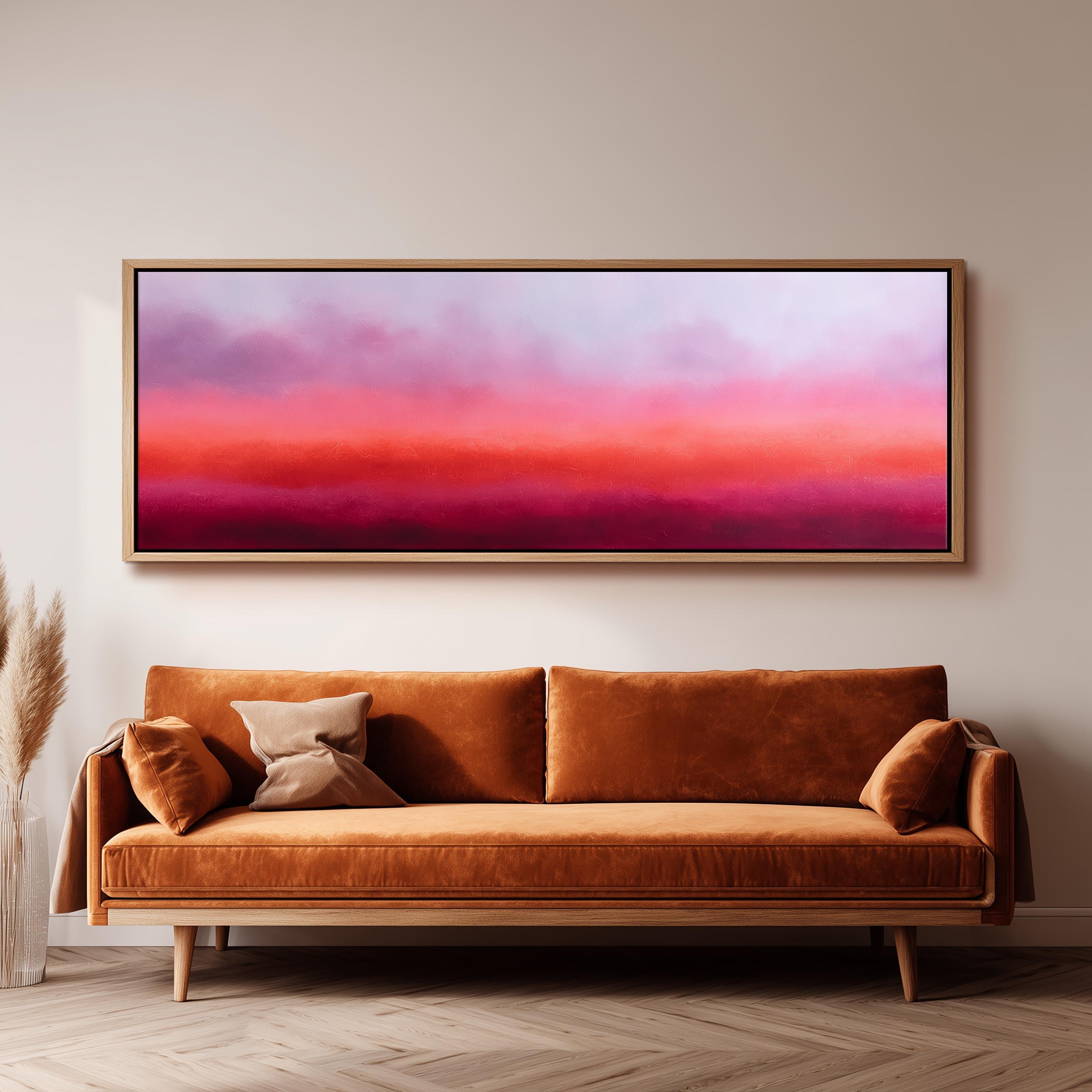 a large, rectangular painting hanging on a wall above a brown sofa with two pillows.