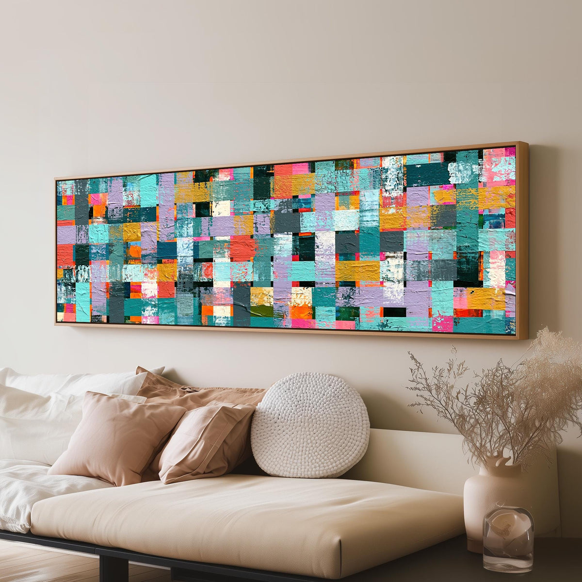 Woven grid of teal and pink blocks long horizontal canvas print above a sofa in a living room