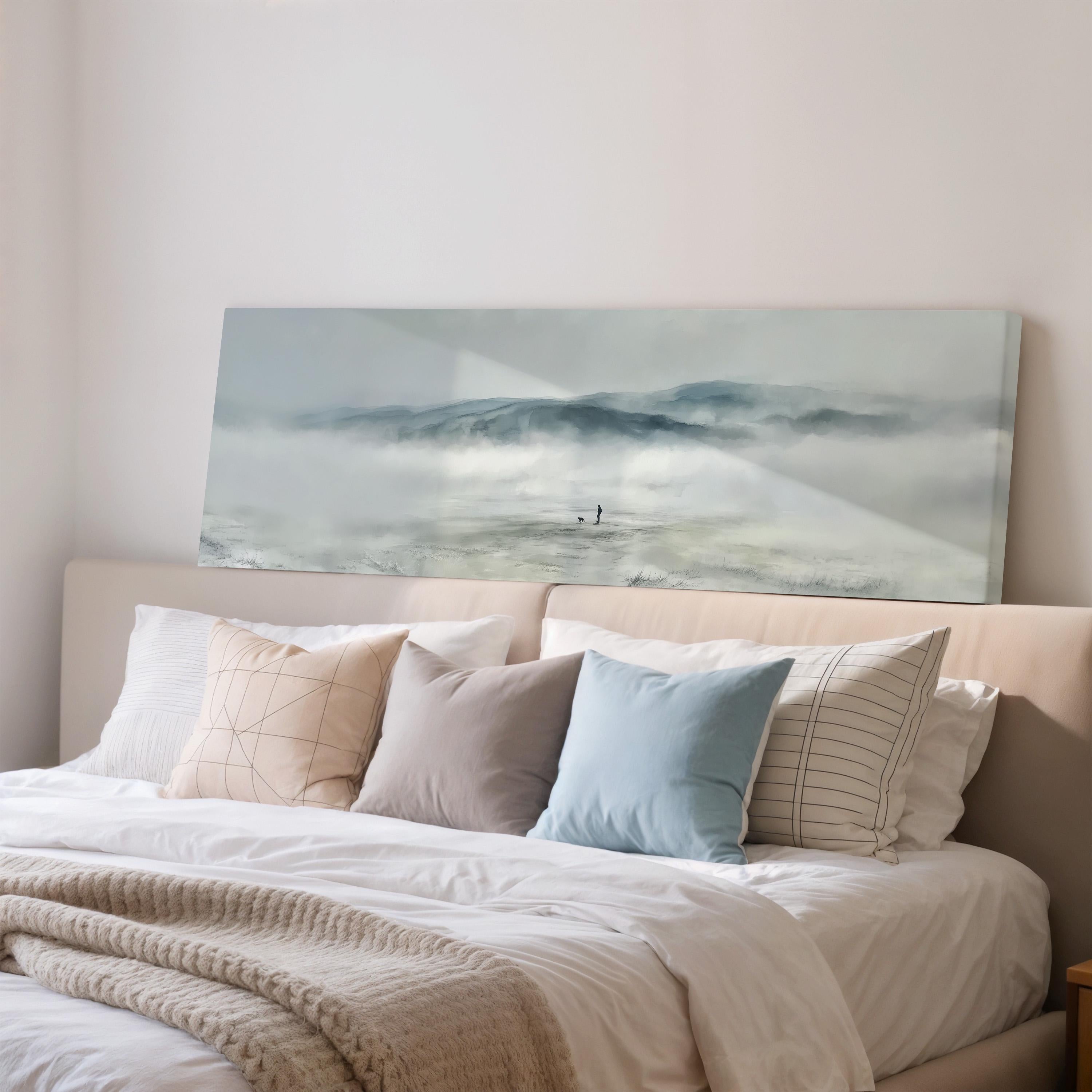 a large, white bed with a painting of a person standing in the mist above it. The bed is adorned with various pillows and a blanket, creating a cozy and inviting atmosphere.