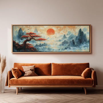 a large, framed painting of a serene landscape with a tree and mountains, hanging on a wall above a brown sofa.