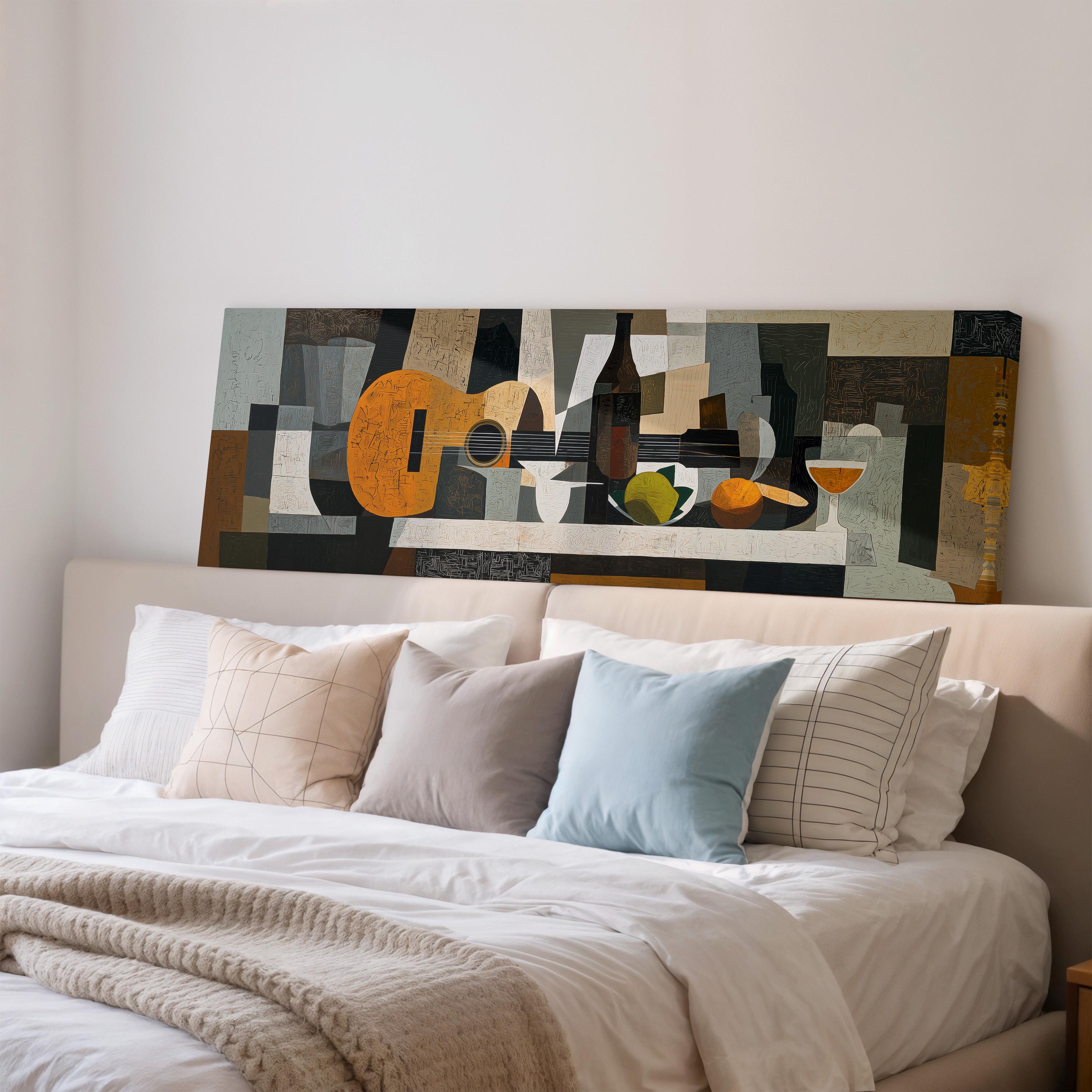 a large abstract painting hanging on a wall above a bed with white pillows and a gray blanket.