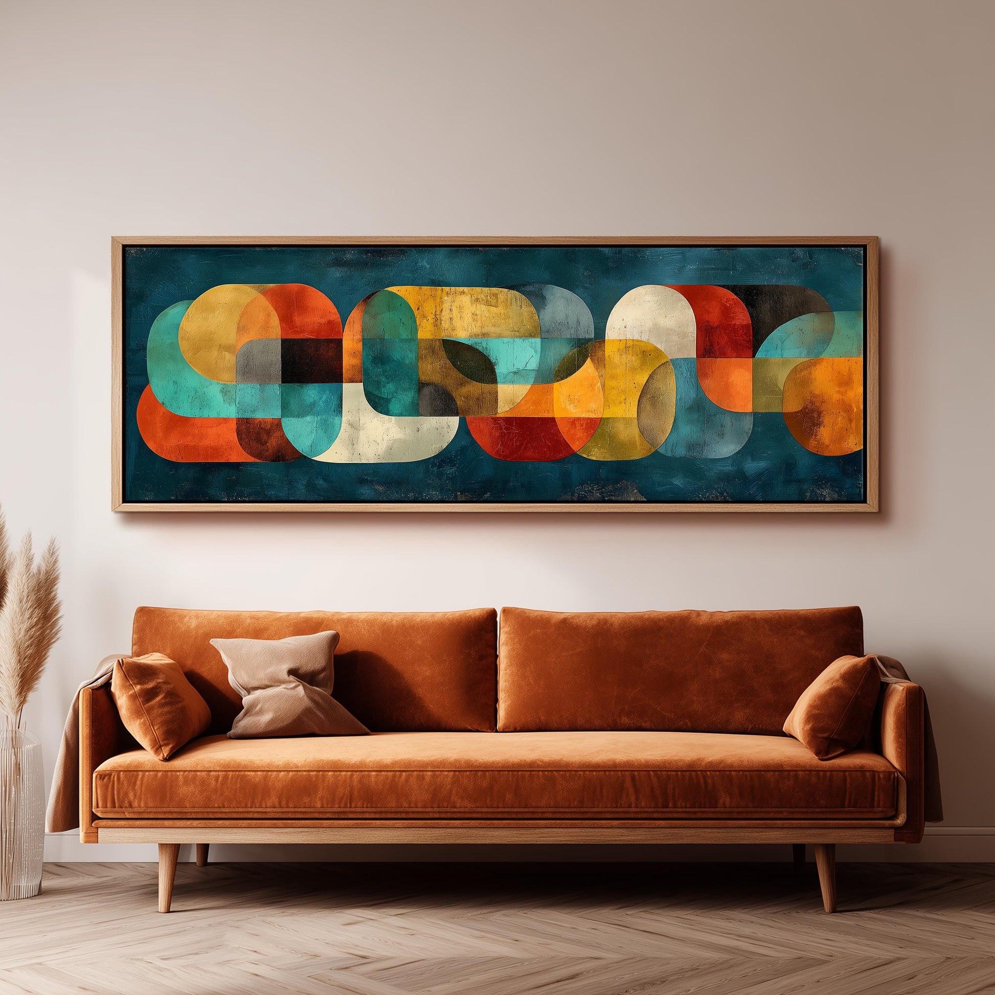 a large abstract painting hanging on a wall above a brown sofa with two pillows.