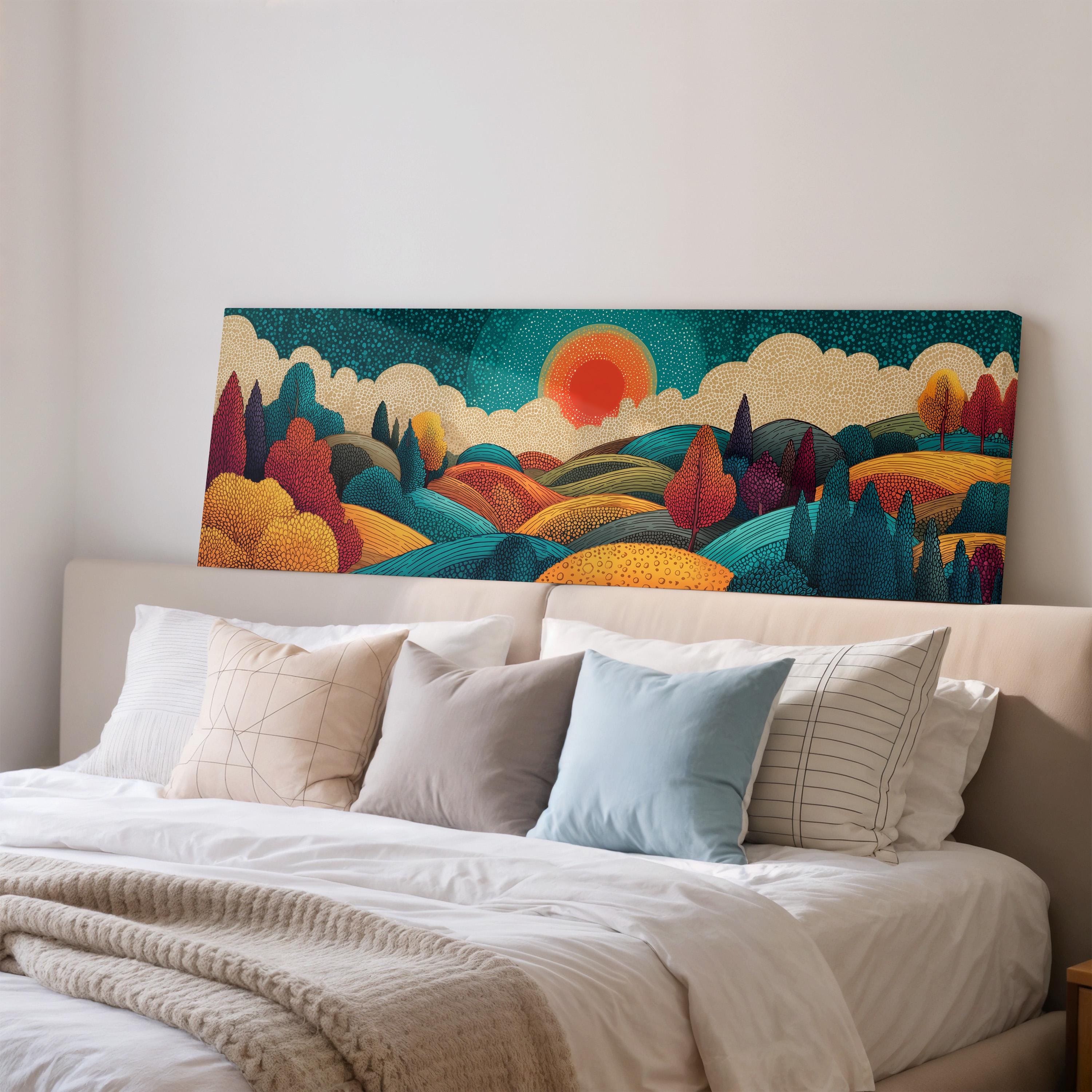 a large, colorful landscape painting hanging on a wall above a bed with white pillows and a gray blanket.