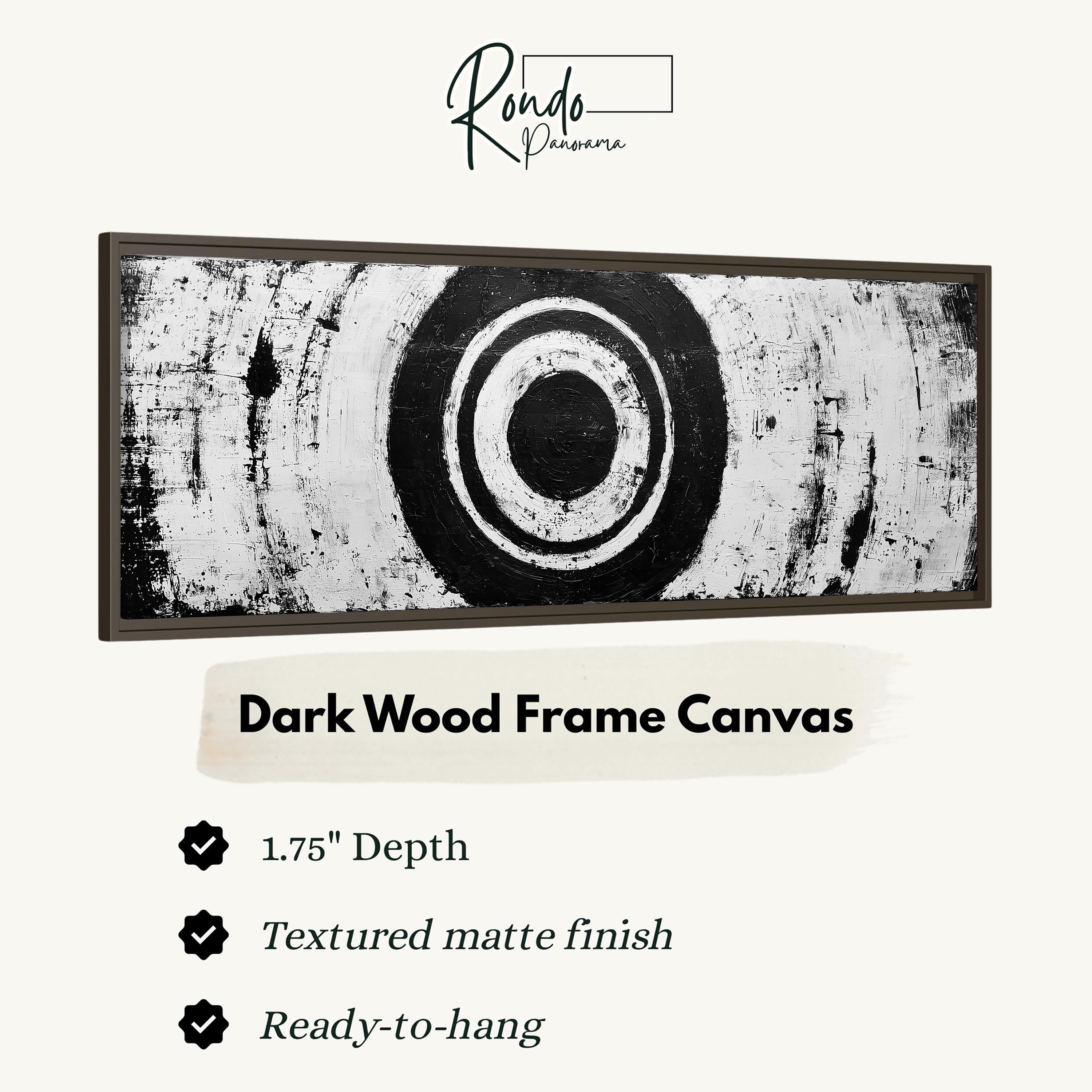 The image is a dark wood frame canvas with a black and white abstract design.