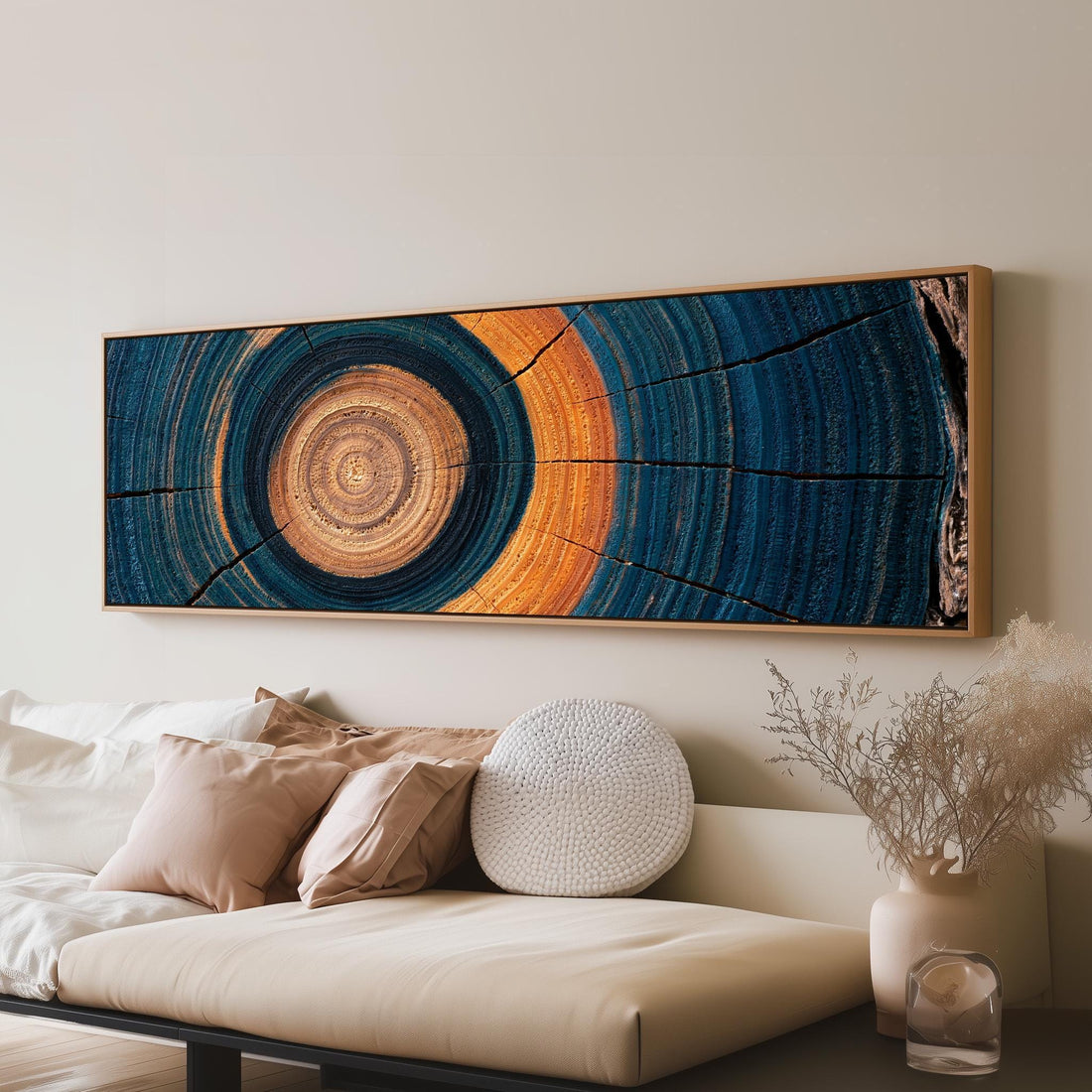 Teal and orange tree ring long horizontal canvas print above a sofa in a living room