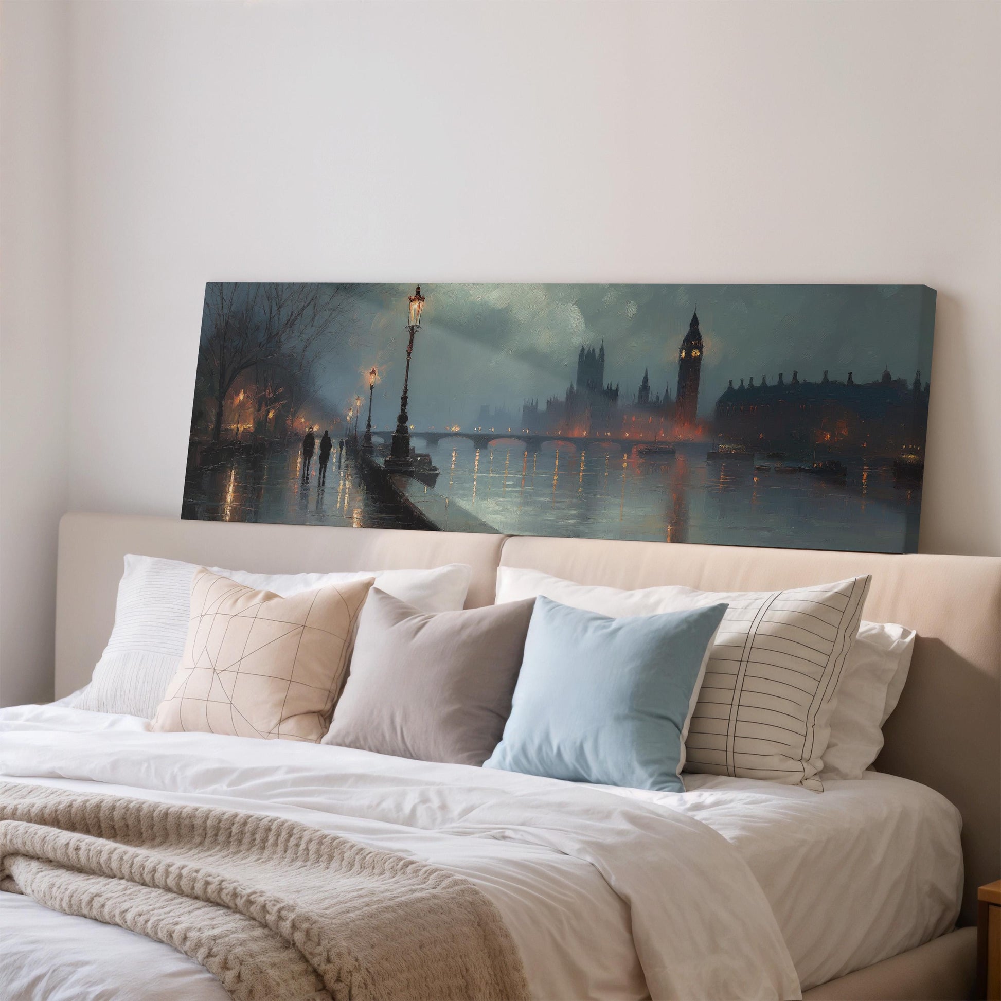 a large painting of a cityscape with a river and a clock tower in the background, hanging on a wall above a bed with pillows.