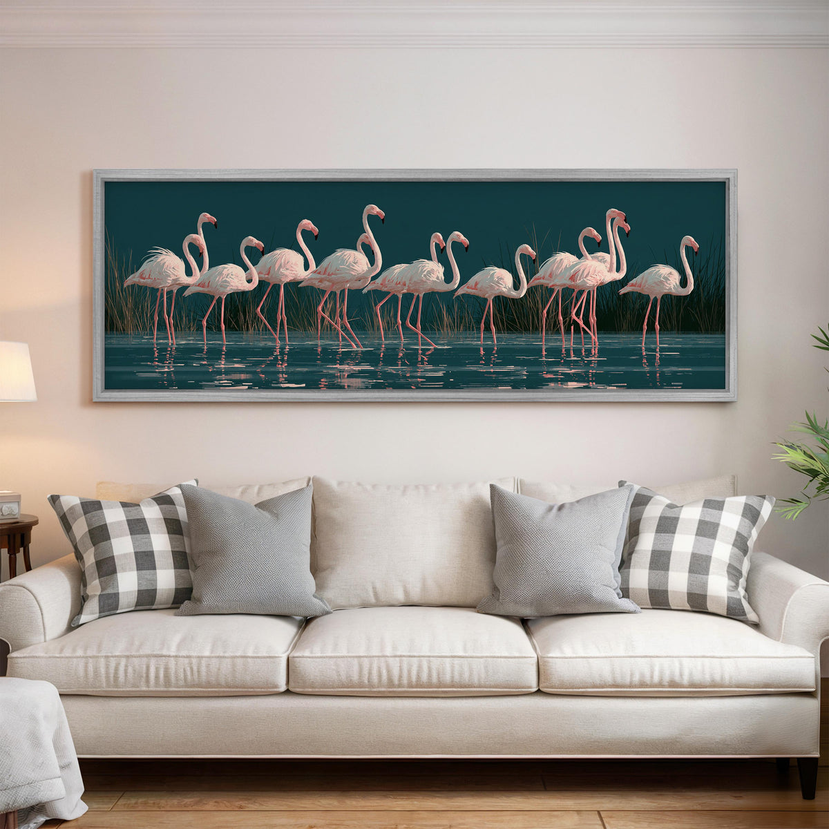 Blush pink flamingos on dark teal water panoramic canvas print above a white sofa in a bright living room