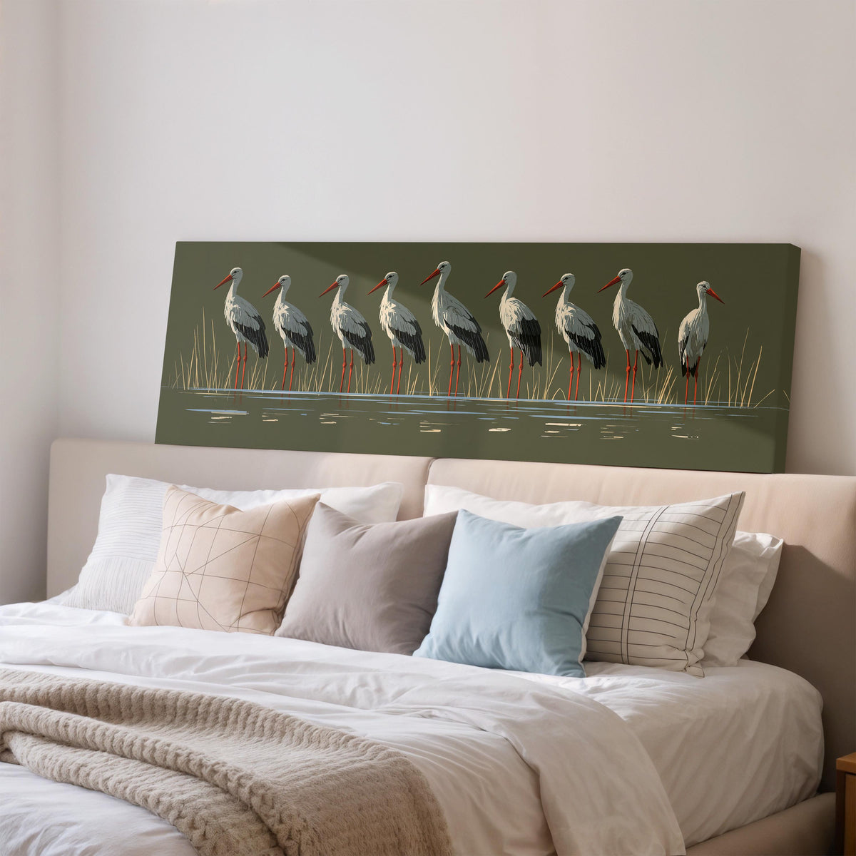 Flock of storks on olive green wide panoramic canvas print above a bed in a bedroom